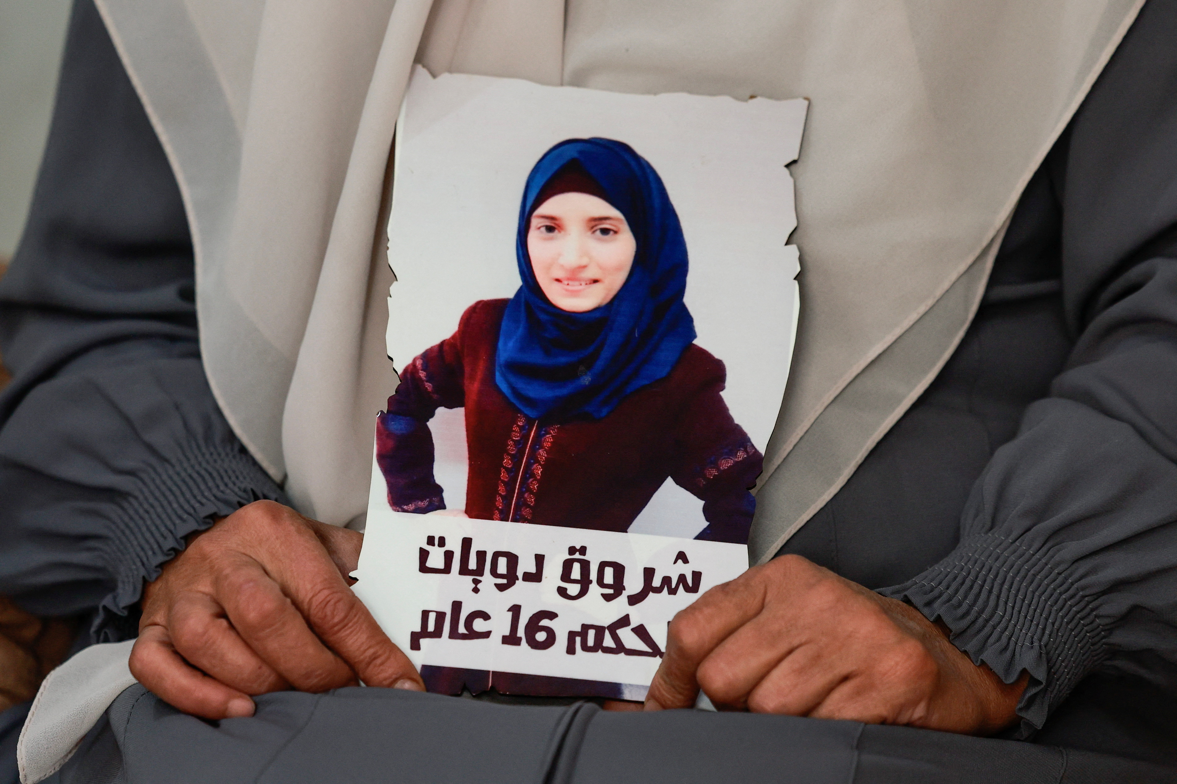 Sameera Dwayyat, the mother of Shorouq Dwayyat, 26, a female Palestinian prisoner serving a 16-year sentence, holds a picture of her daughter,