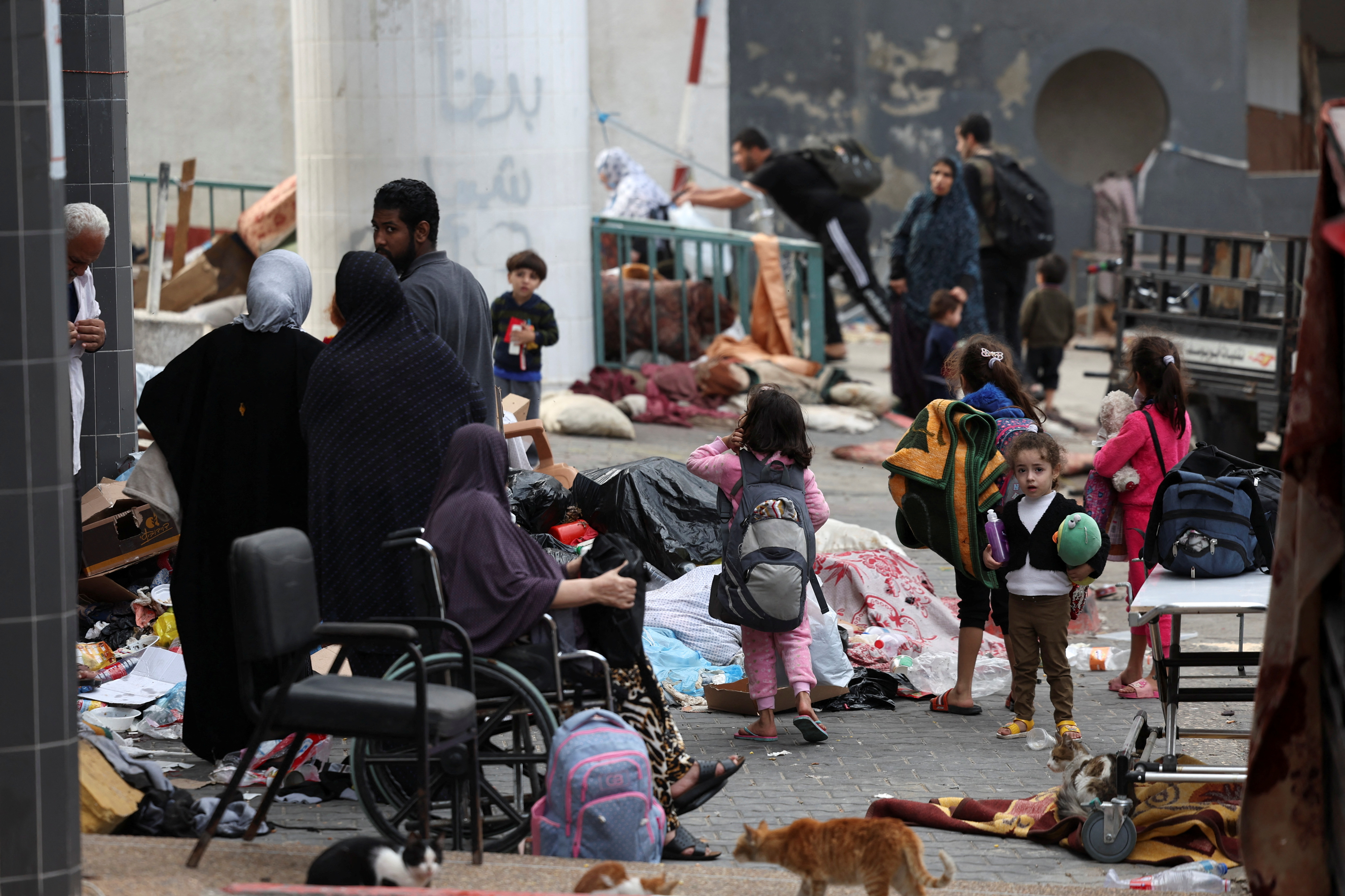 Palestinians gather at Al Shifa Hospital compound in Gaza City, amid the ongoing ground operation of the Israeli army against Palestinian Islamist group Hamas, in the Gaza Strip