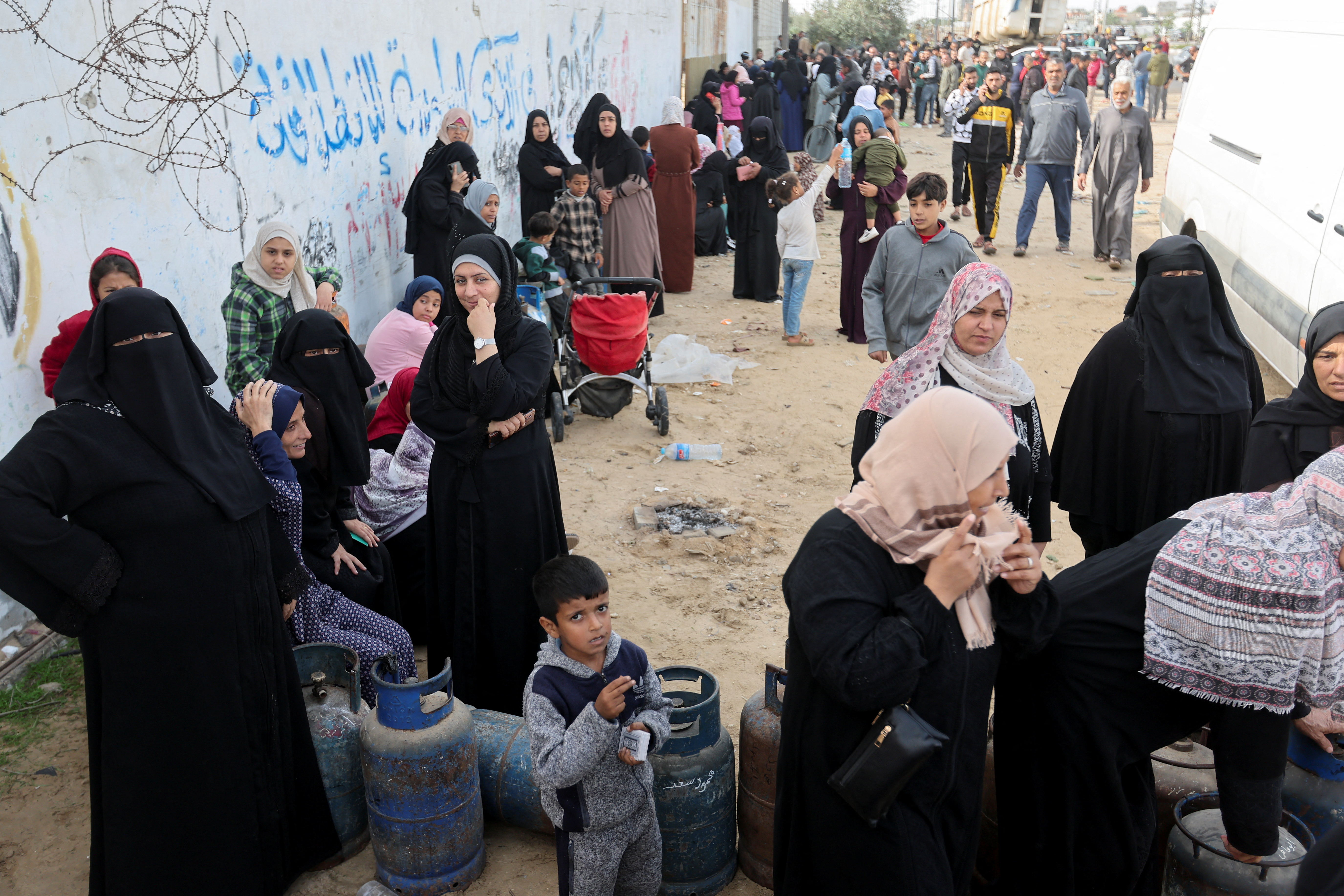 Palestinians gather to buy fuel, amid fuel shortages, during a temporary truce between Hamas and Israel, in Rafah in the southern Gaza Strip November 25
