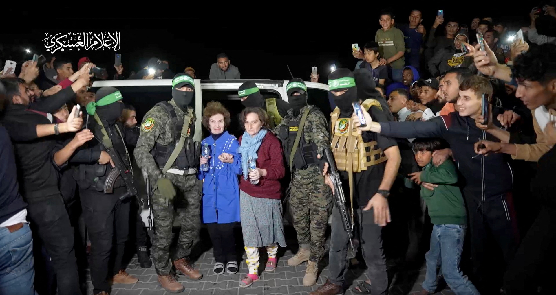 Captives are handed over by Hamas fighters to the International Red Cross