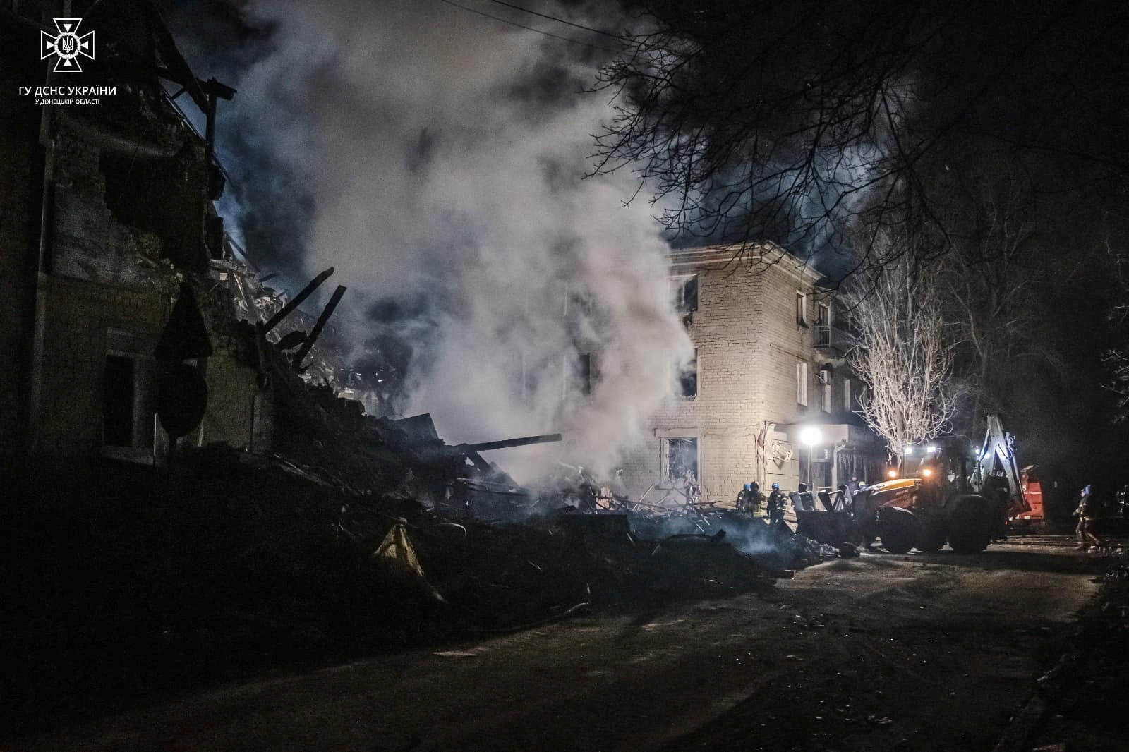 Rescuers work at a site of a residential building heavily damaged by a Russian missile strike