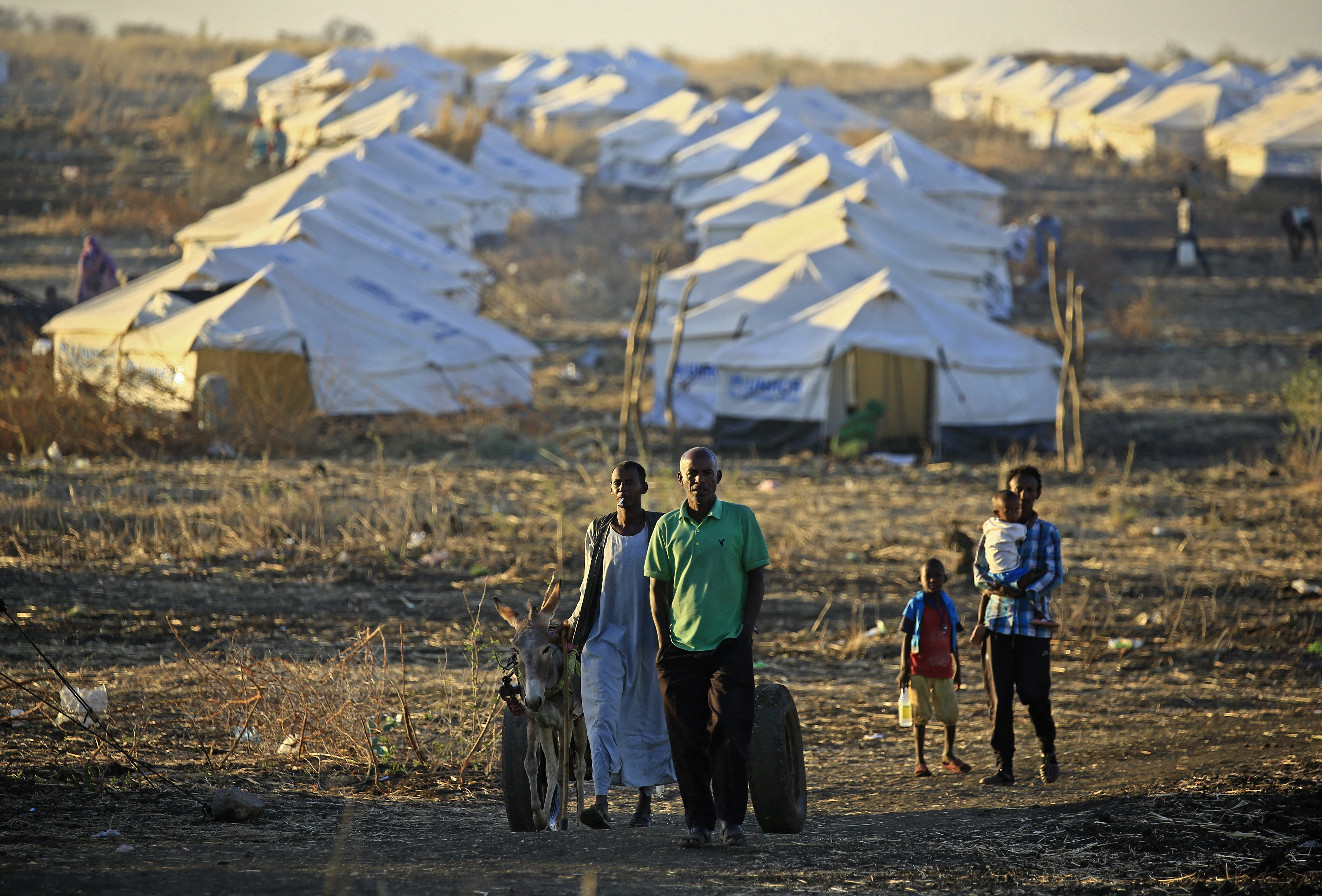 Ethiopian refugees walk together early in the morning on Coptic Christmas day at Um Raquba refugee camp in Gedaref, eastern Sudan.