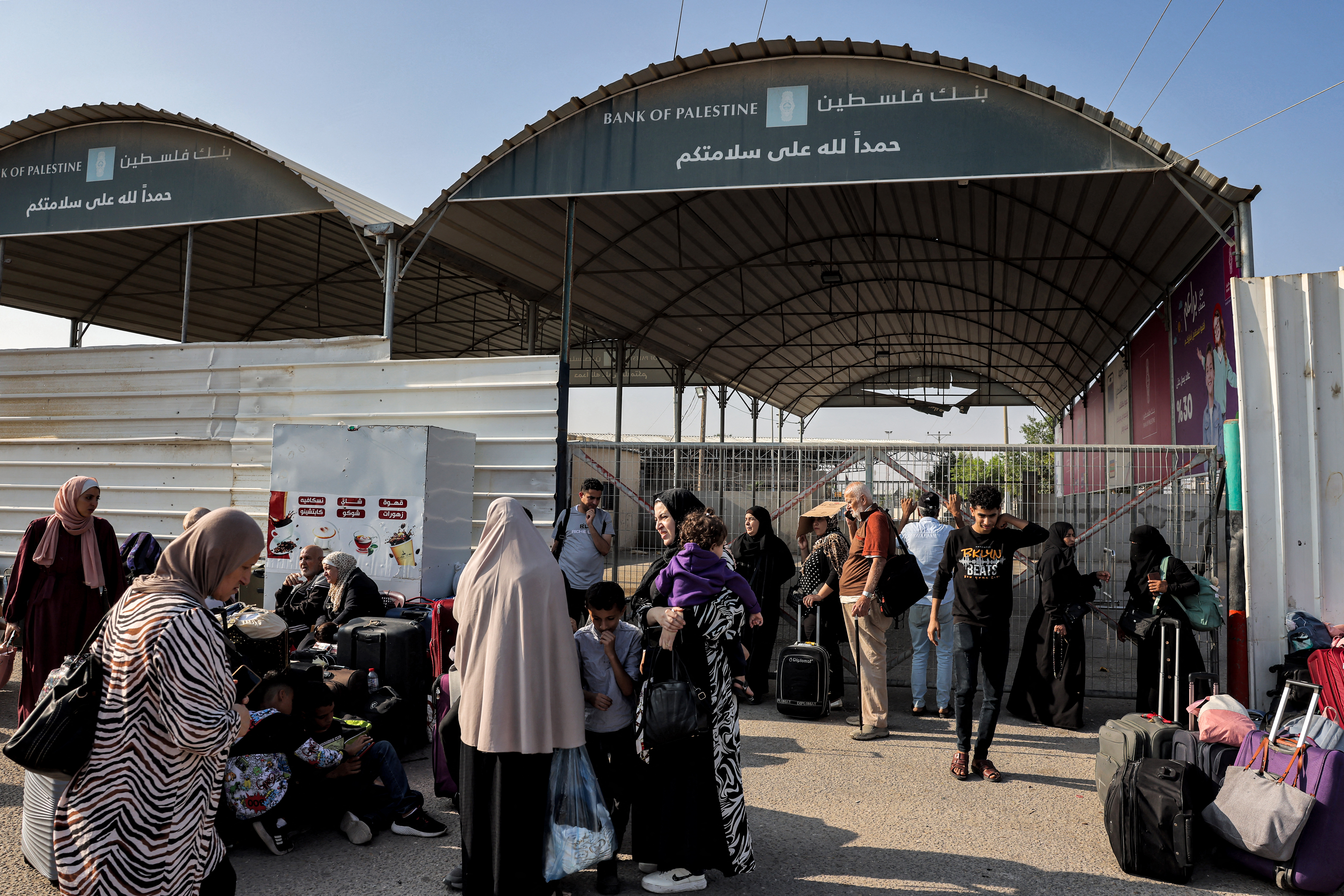 People wait at the Rafah border crossing with Egypt in the southern Gaza Strip on November 1, 2023