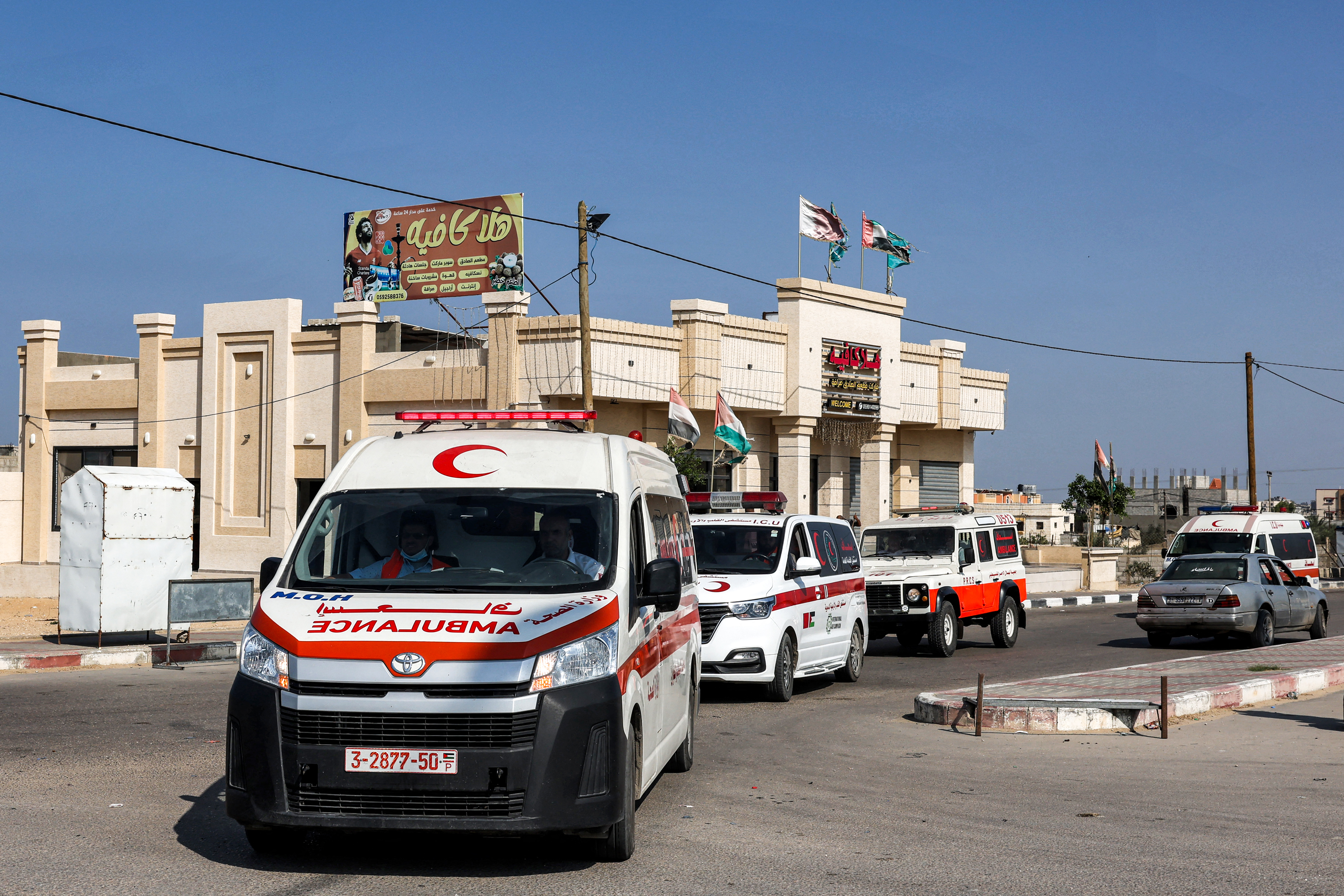 Palestinian health ministry ambulances arrive outside the Rafah border crossing