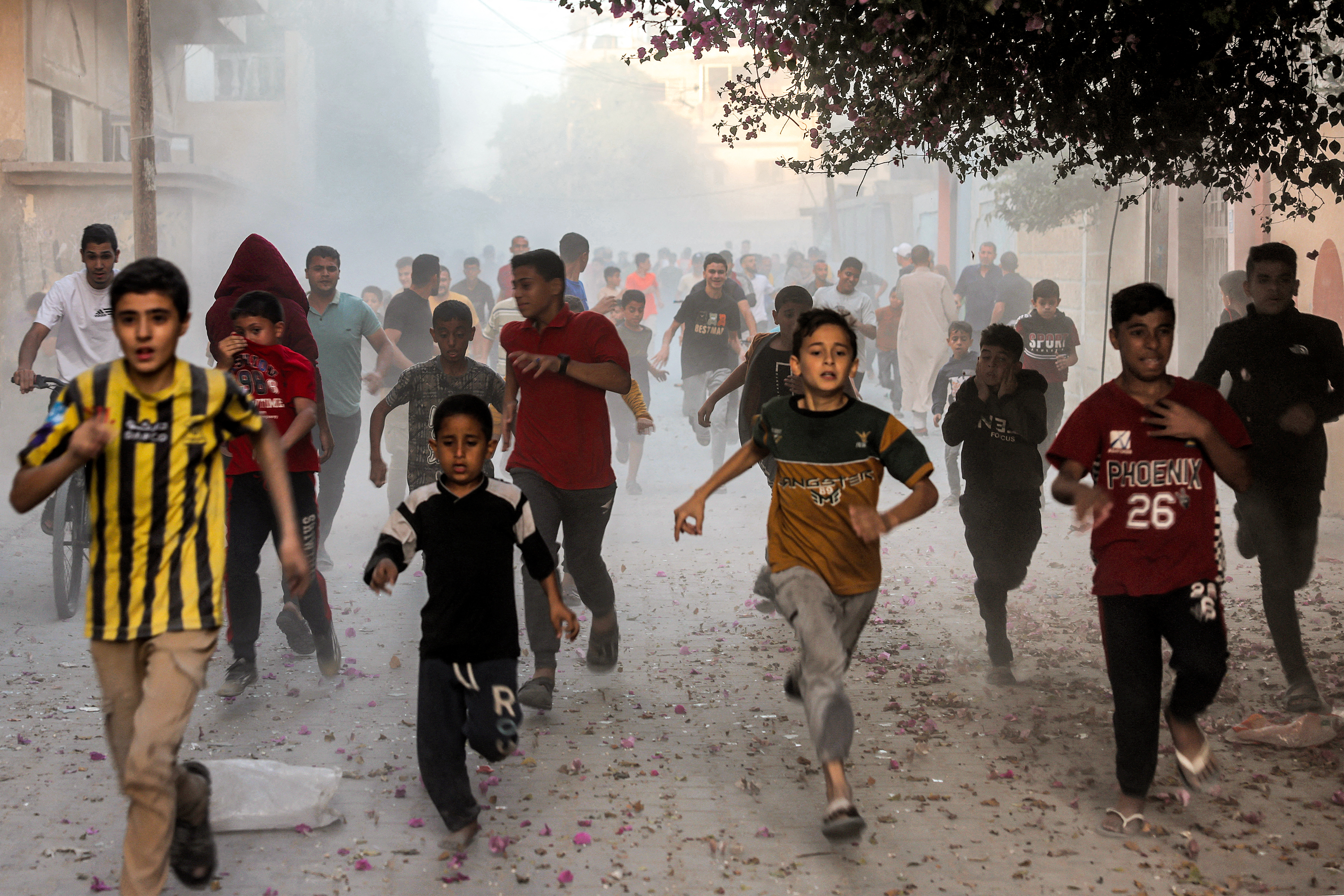 Palestinian children run as they flee from Israeli bombardment in Rafah in the southern Gaza Strip on November 6, 2023, amid continuing battles between Israel and the Palestinian militant group Hamas.