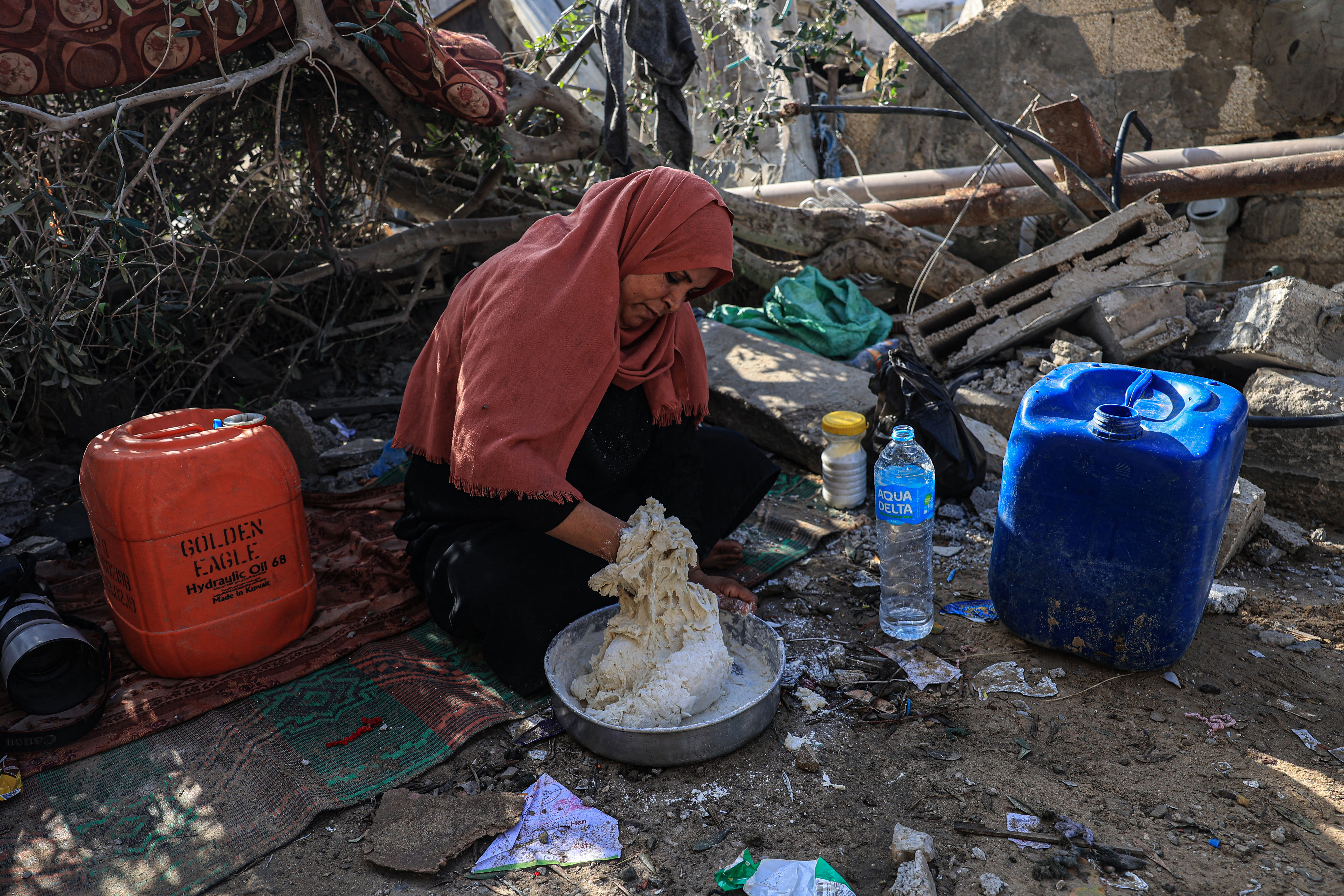 Nesrine, Amal al-Robayaa's sister-in-law, mixes flour with water to make bread