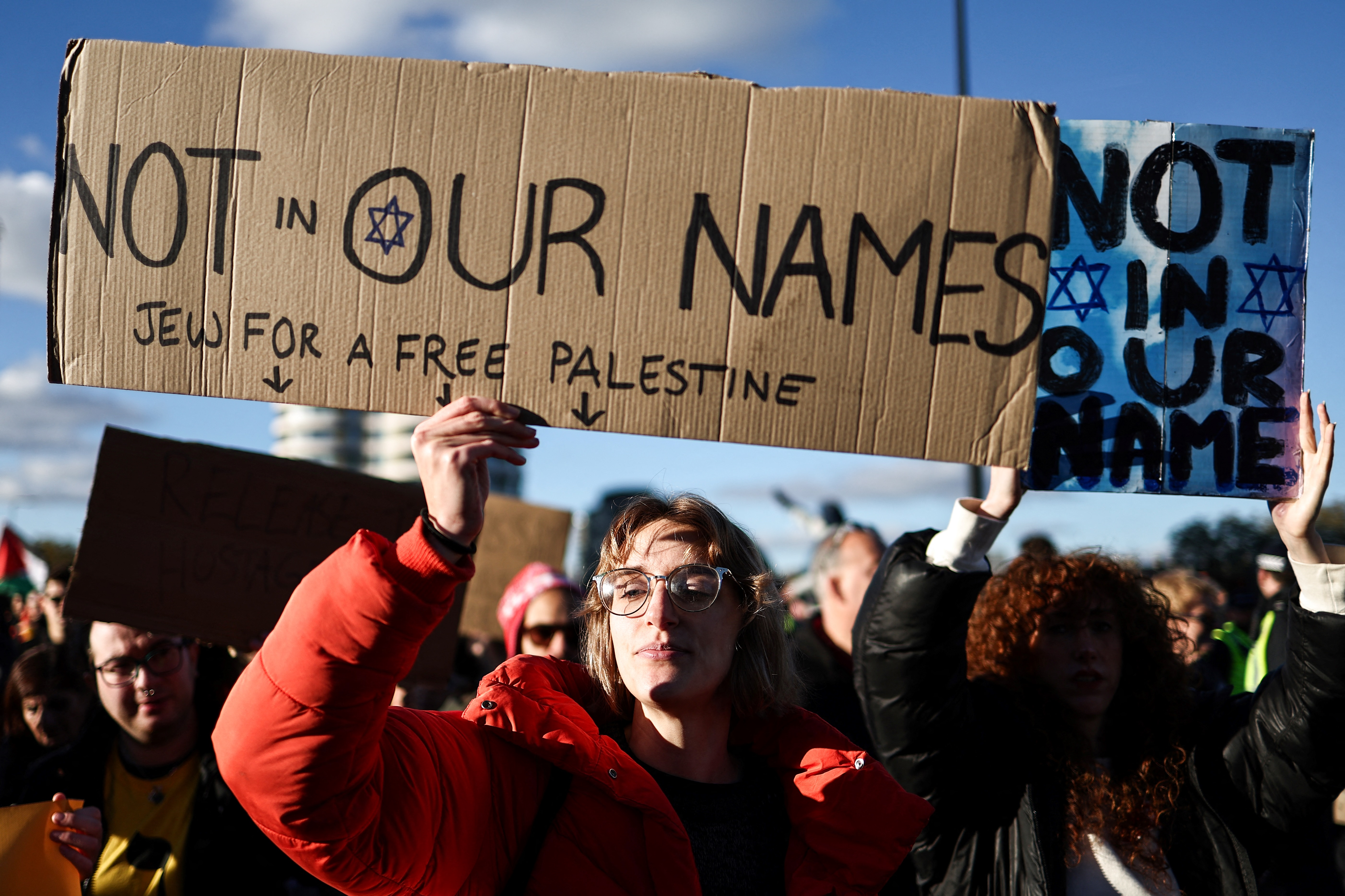 Protesters holding placards and flags, take part in the 'National March For Palestine' in central London