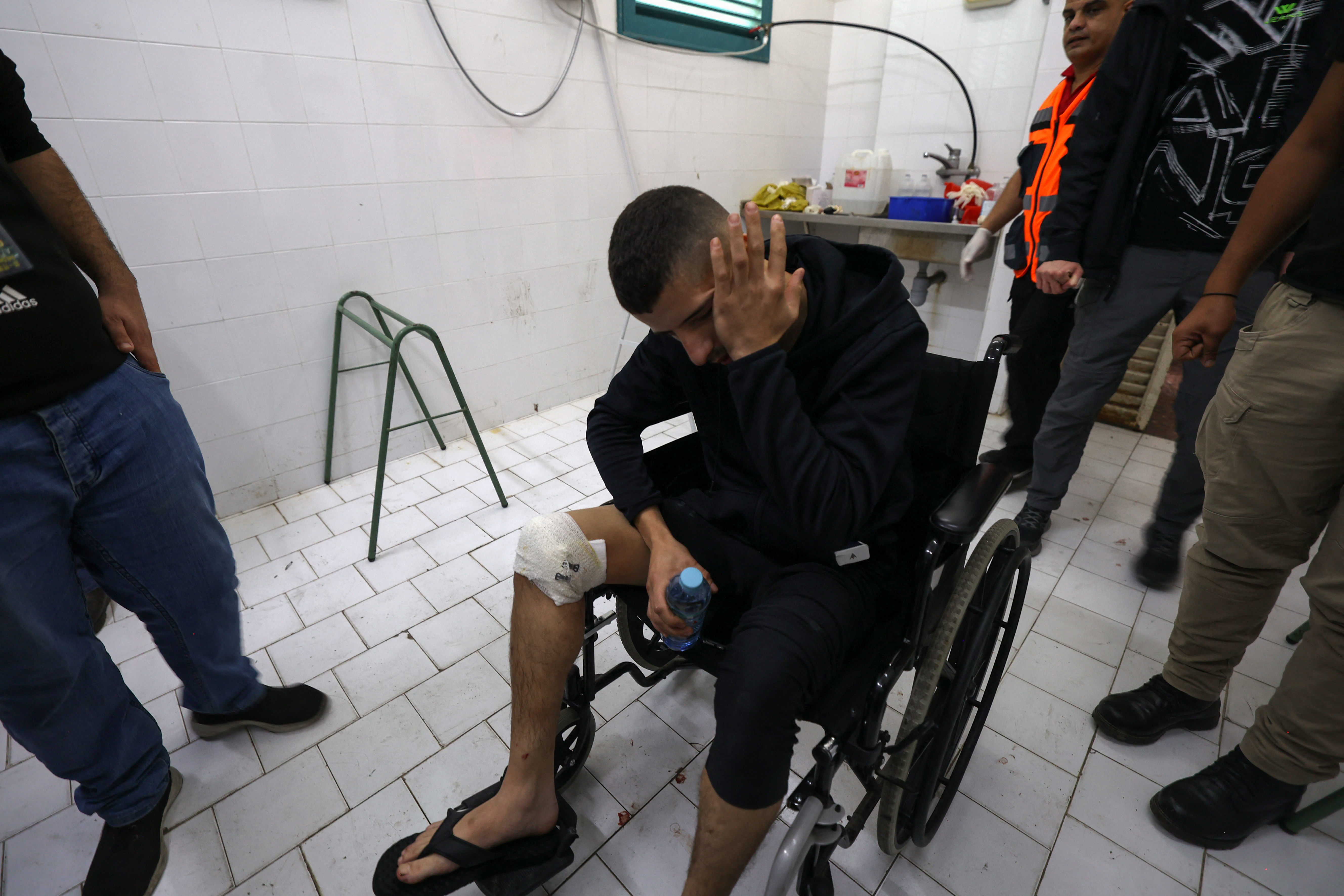 An injured man reacts by the bodies (not pictured) of Palestinians killed in clashes with Israeli forces during an operation in Tulkarm, at the Thabet hospital morgue in the same city in the occupied West Bank.