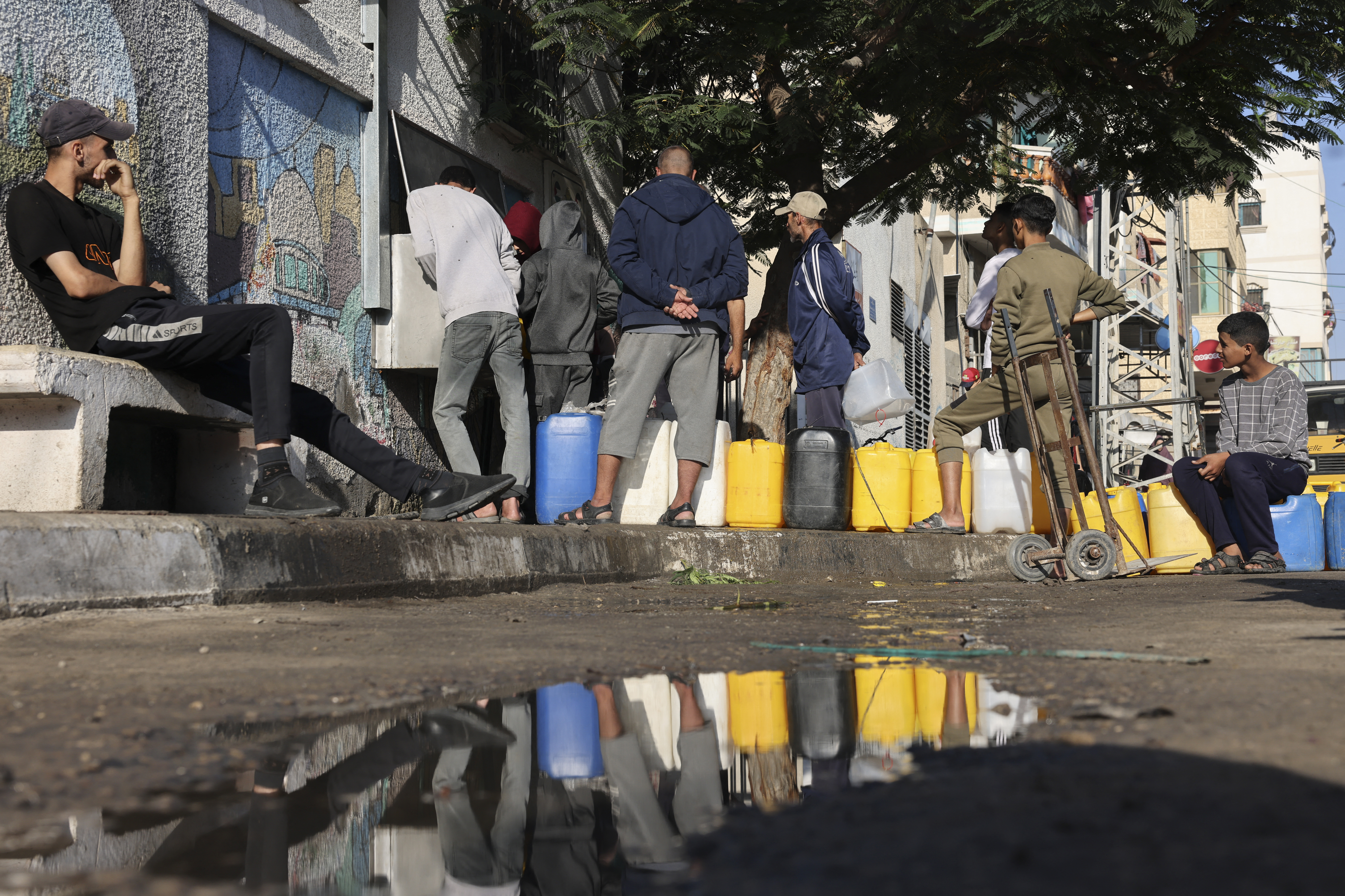 Palestinians queue for clean water in Rafah in the southern Gaza Strip.