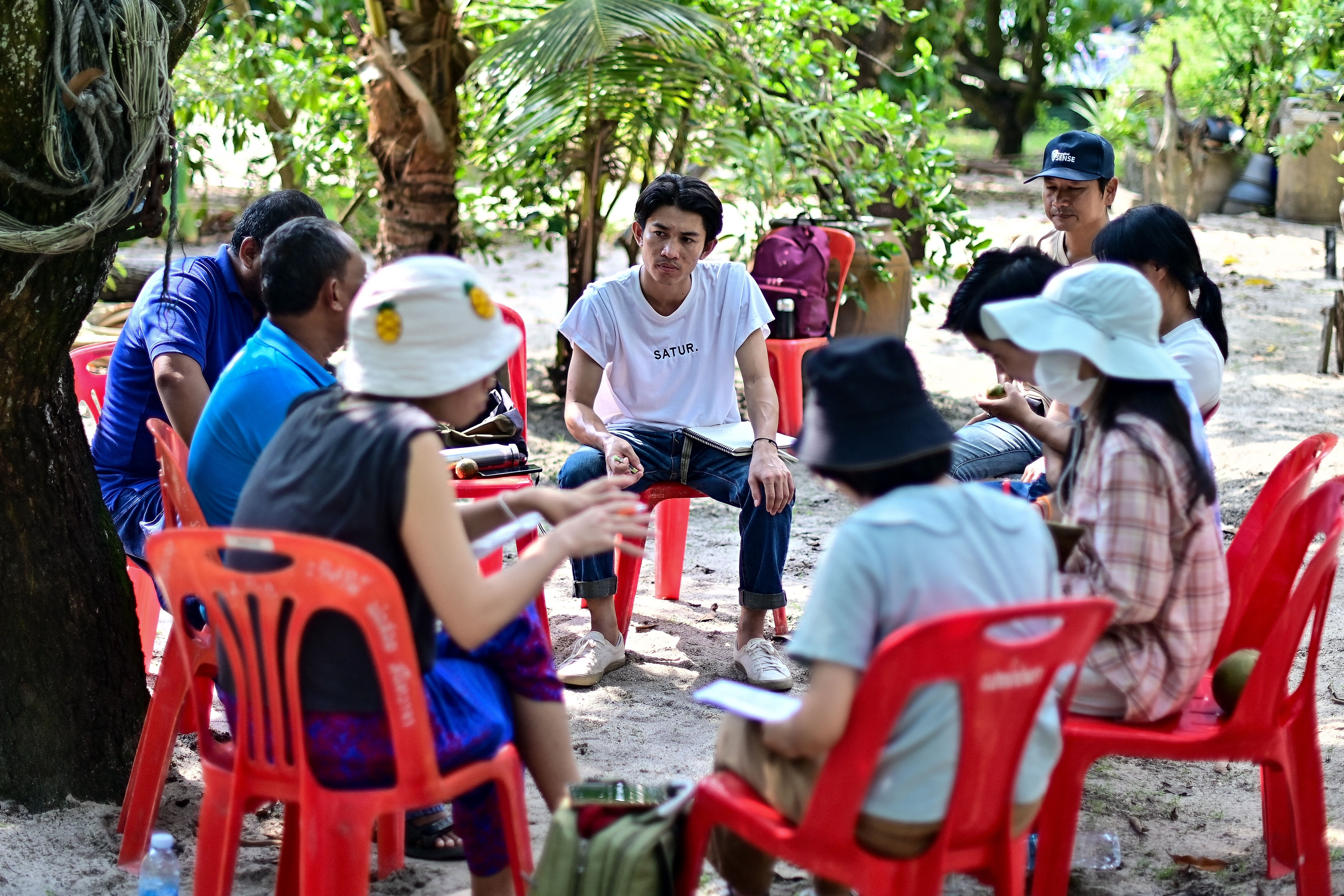 This photograph taken on November 7, 2023 shows Kino Khanhthamaly (C), an environmentalist working in Laos, during an EarthRights School field trip in the coastal Thai province of Rayong.