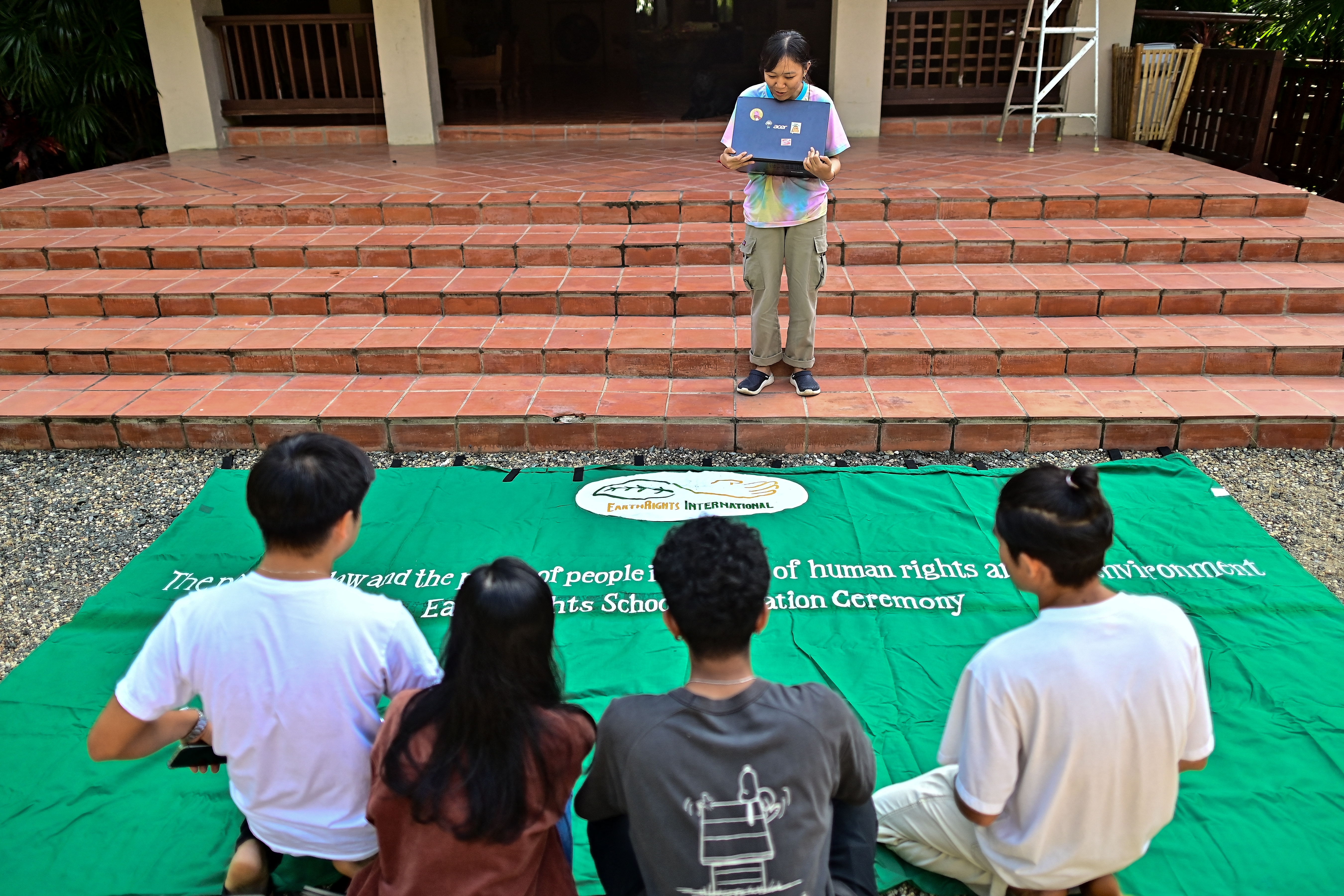 This photograph taken on November 21, 2023 shows San Somanear (C), an environmentalist from Cambodia, talking to fellow students at the EarthRights School in Chiang Mai.