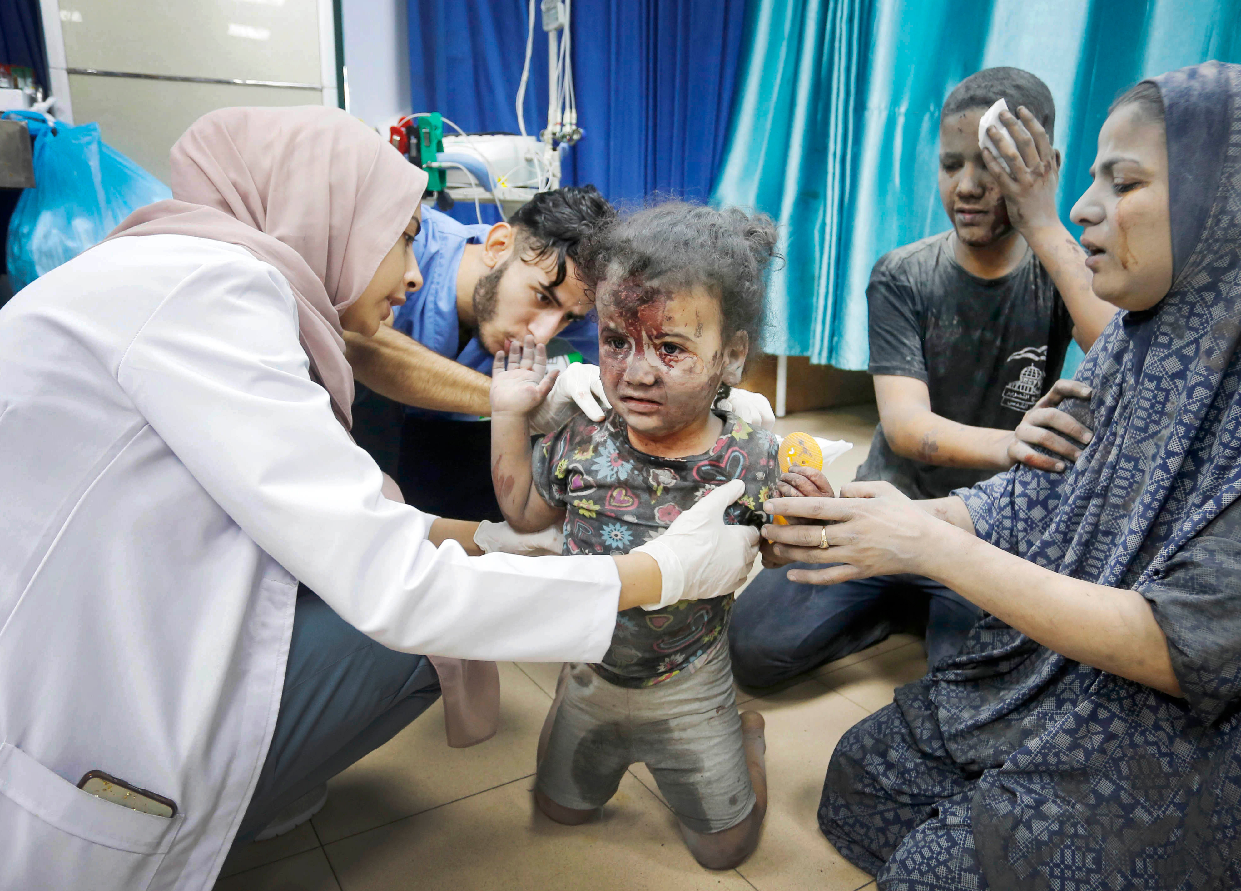 A doctor examines an injured child at the Al Aqsa Hospital after the Israeli attack on Maghazi Refugee Camp in Deir al Balah, Gaza