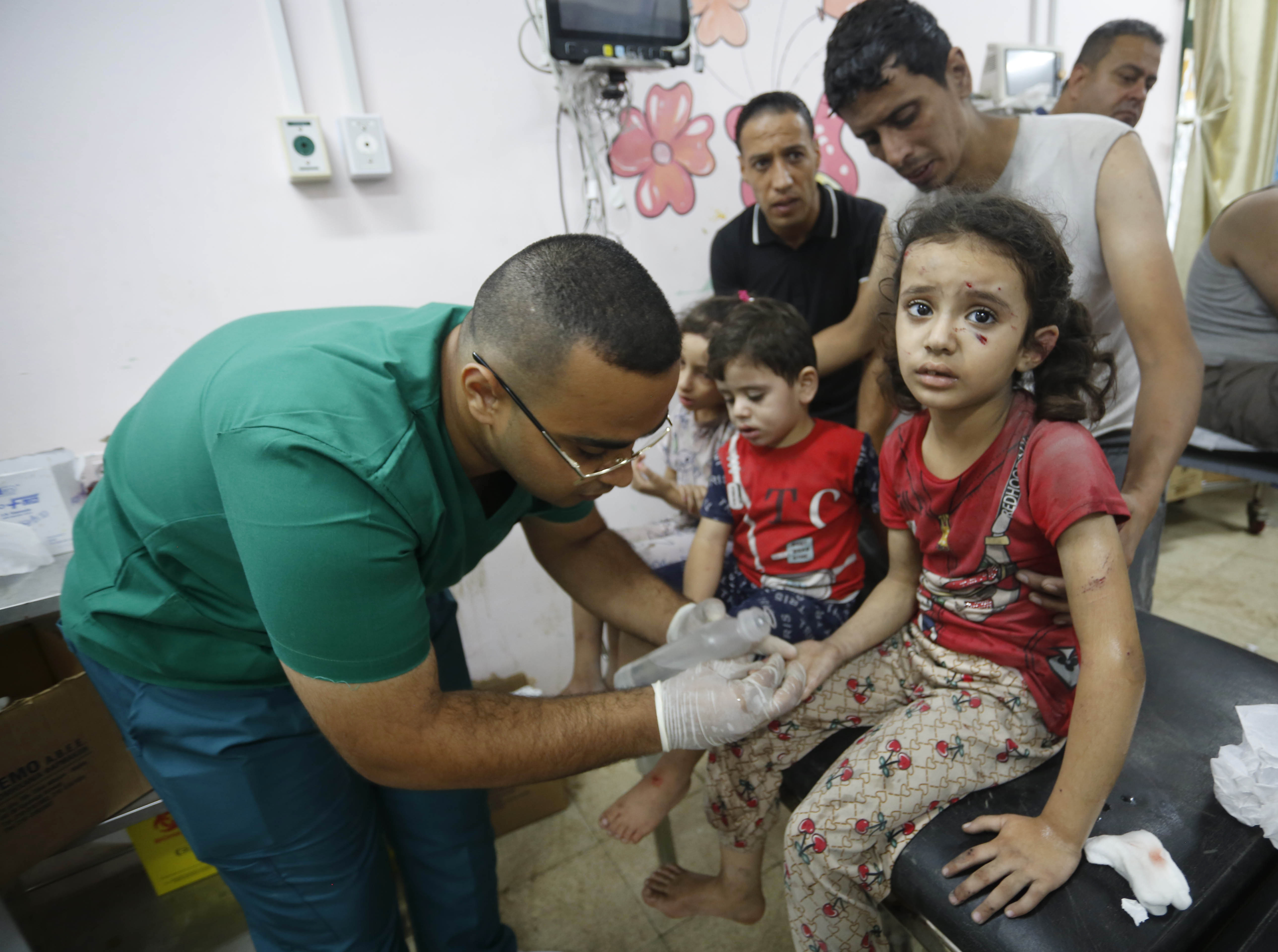 Doctors treat injured children in Israeli attacks at Al-Aqsa Martyrs Hospital in Deir Al Balah, Gaza