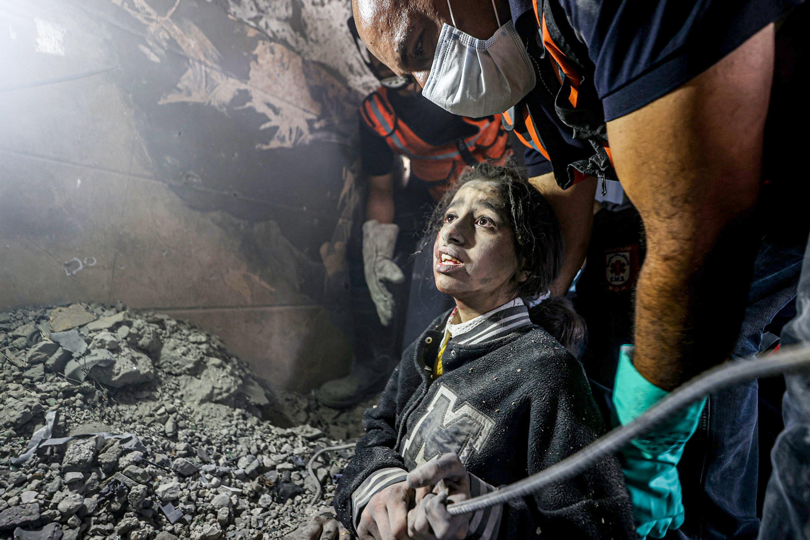 A woman and 13-year-old a girl, May Saad are rescued alive under the rubble of the destroyed building belonging to Al Astal family by civil defense teams and local people as Israeli attacks continue on the 32nd day, in Khan Yunis