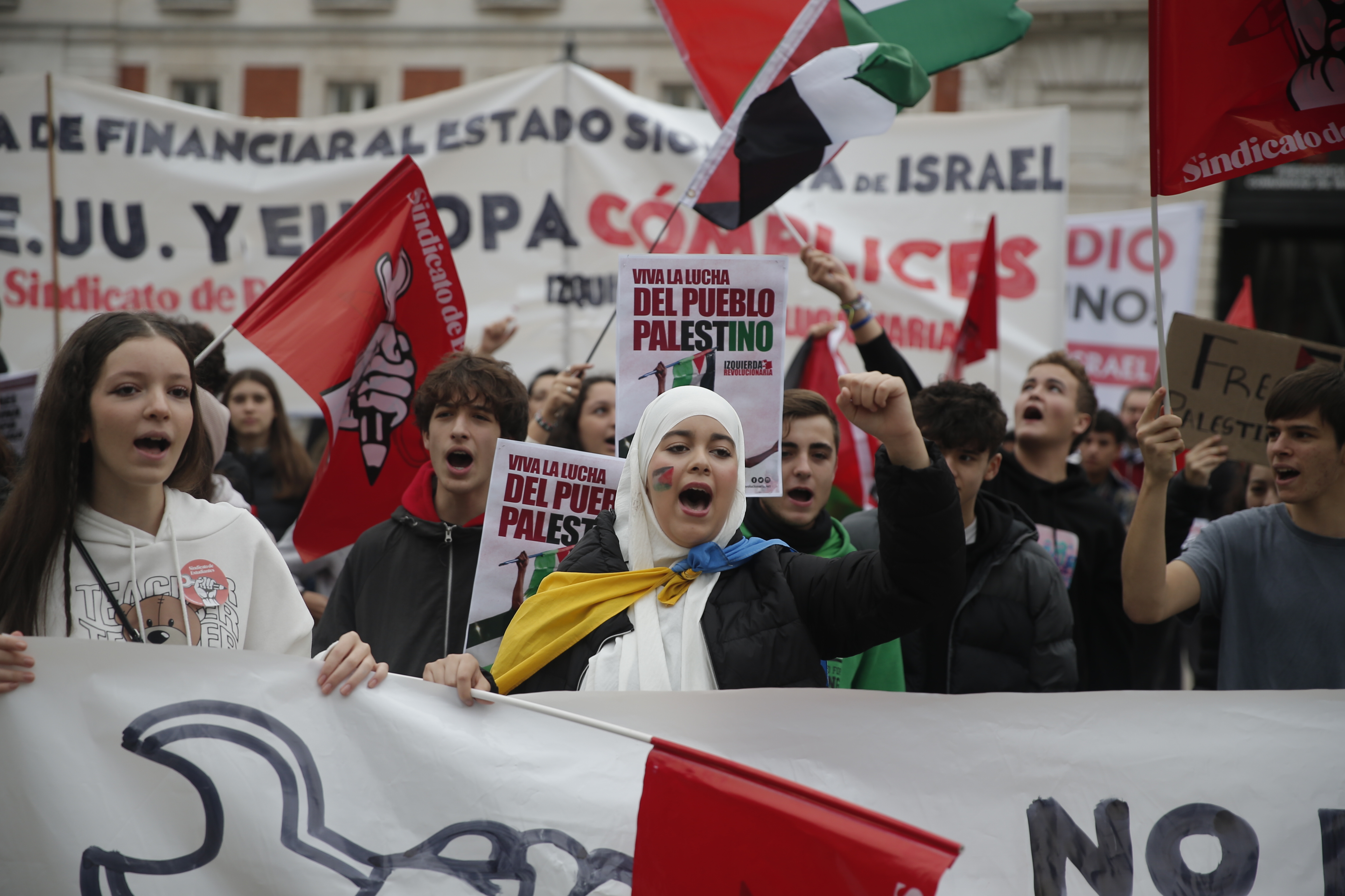 Students, holdings placards and flags, gather to stage protest in support of Palestinians in Madrid, Spain.