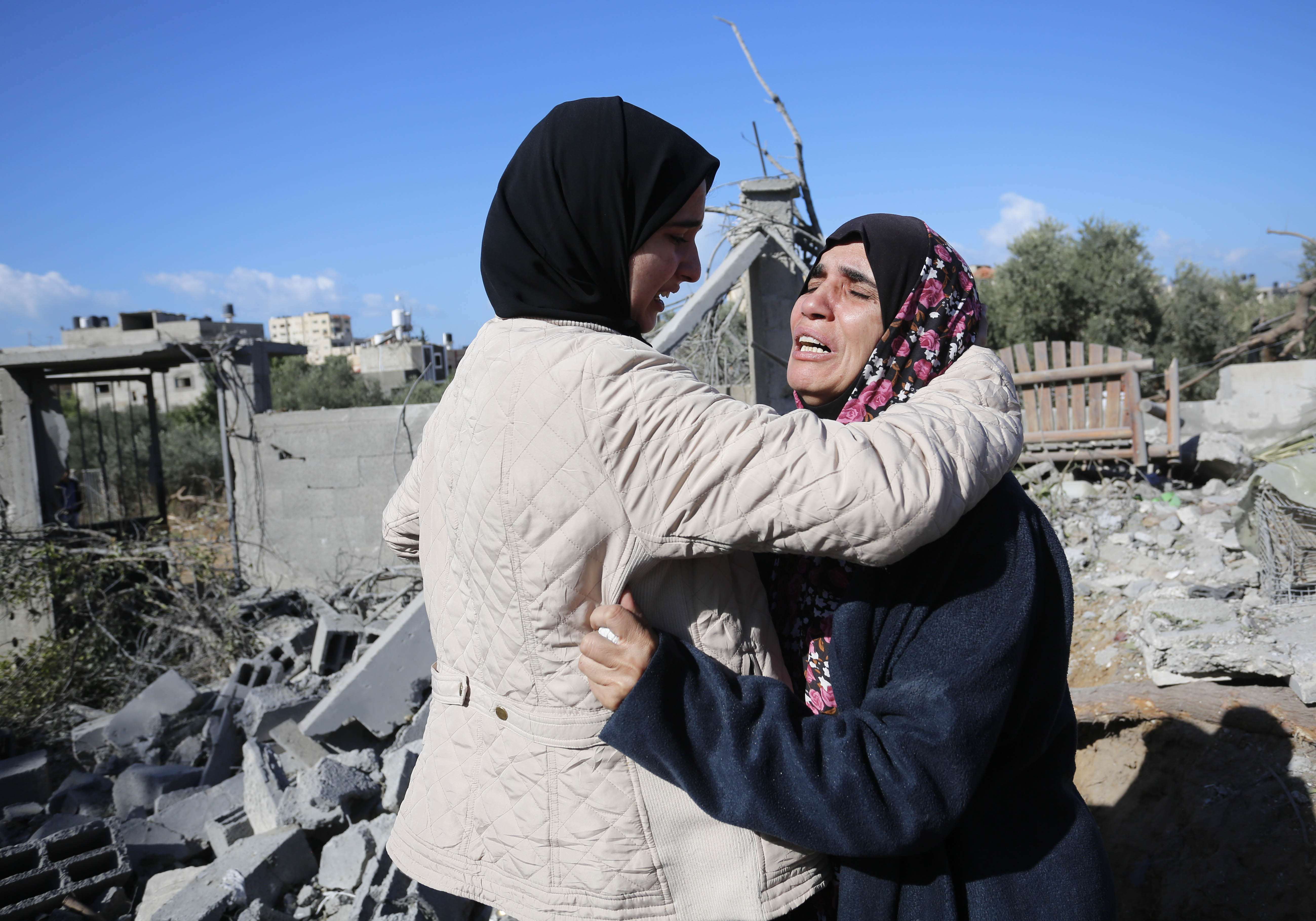 People mourn following an Israeli attack on a house belonging to the al-Haj family at the Nuseirat refugee camp in Deir al-Balah, Gaza.