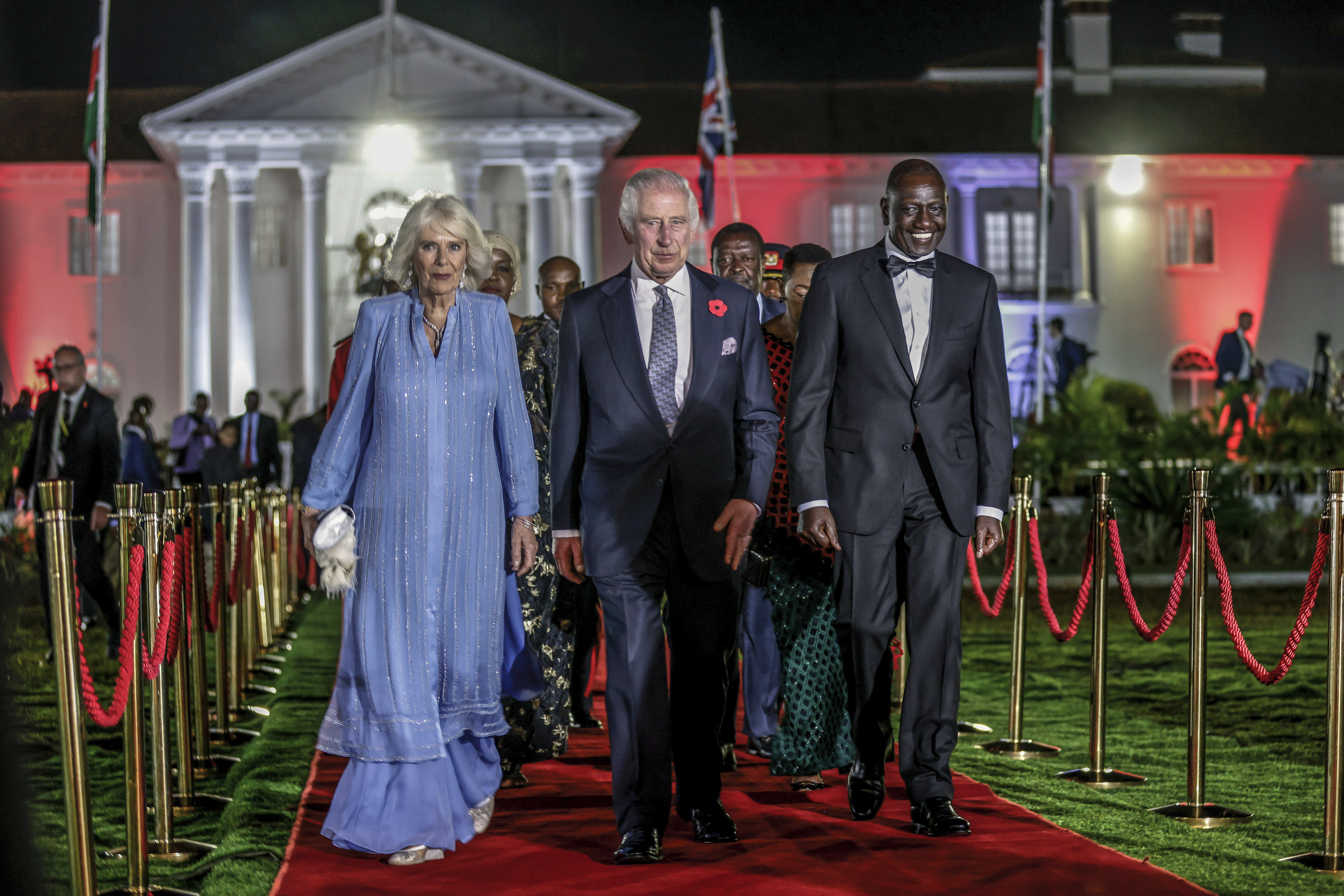 Britain's King Charles III, center, Queen Camilla and Kenyan President William Ruto, right, arrive for the State Banquet at the State House in Nairobi, Kenya