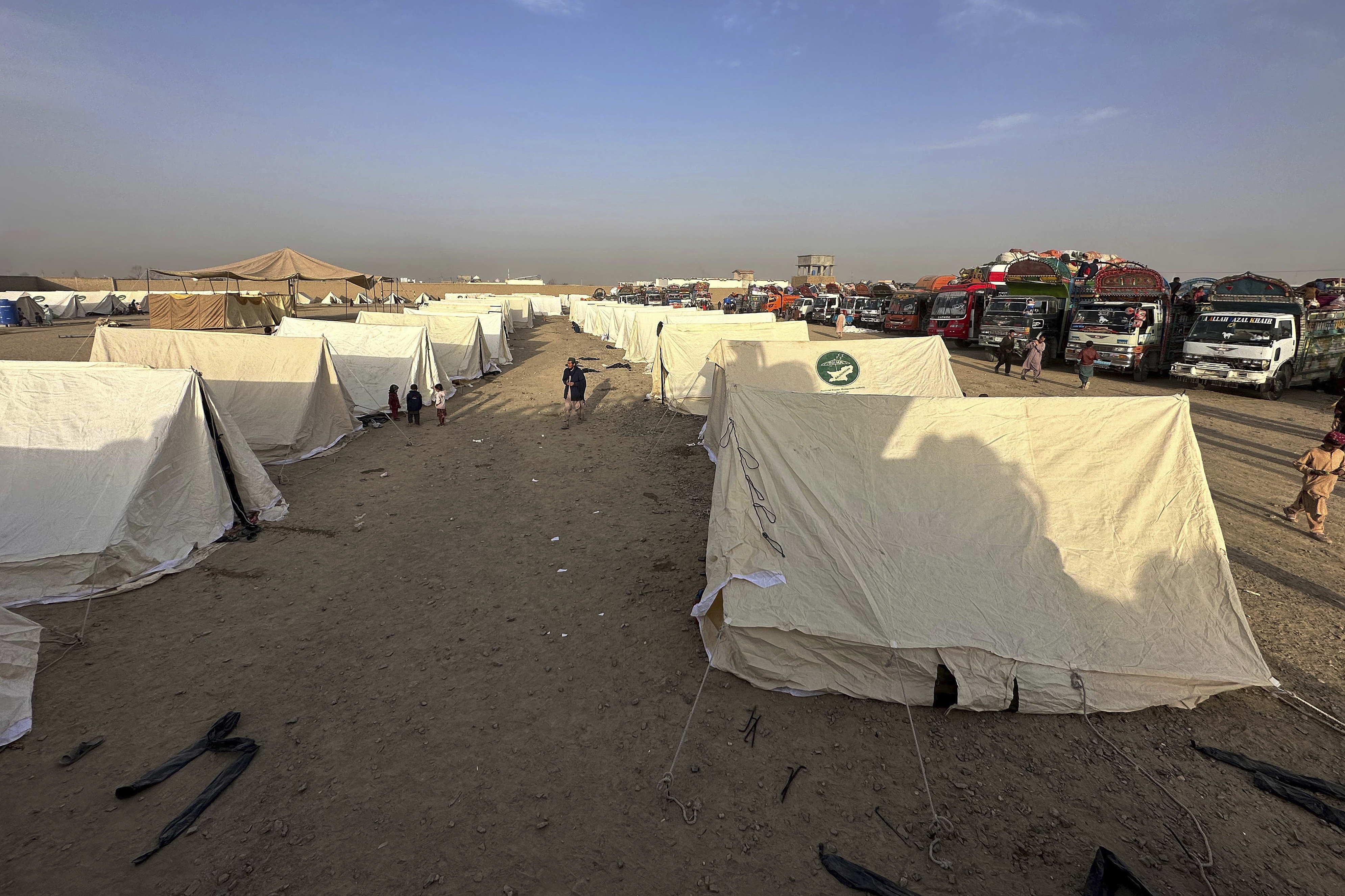 Afghans children play beside their tent as they with others wait for clearance to depart for their homeland at a deportation camp set up by authorities to facilitate illegal immigrants, in Chaman, a town on the Pakistan-Afghanistan border.