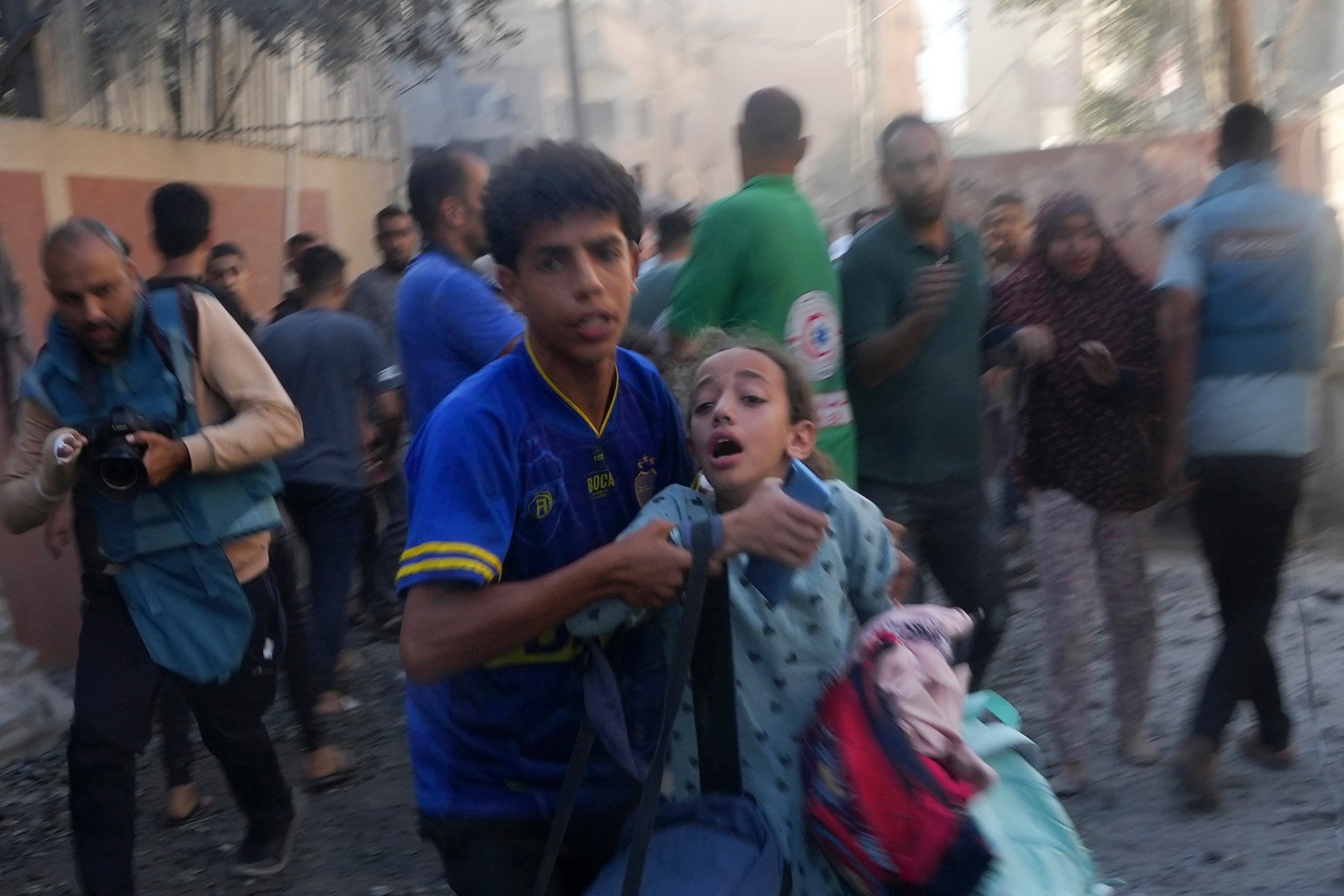 Palestinians evacuate survivors after Israeli airstrikes on buildings in Deir al Balah