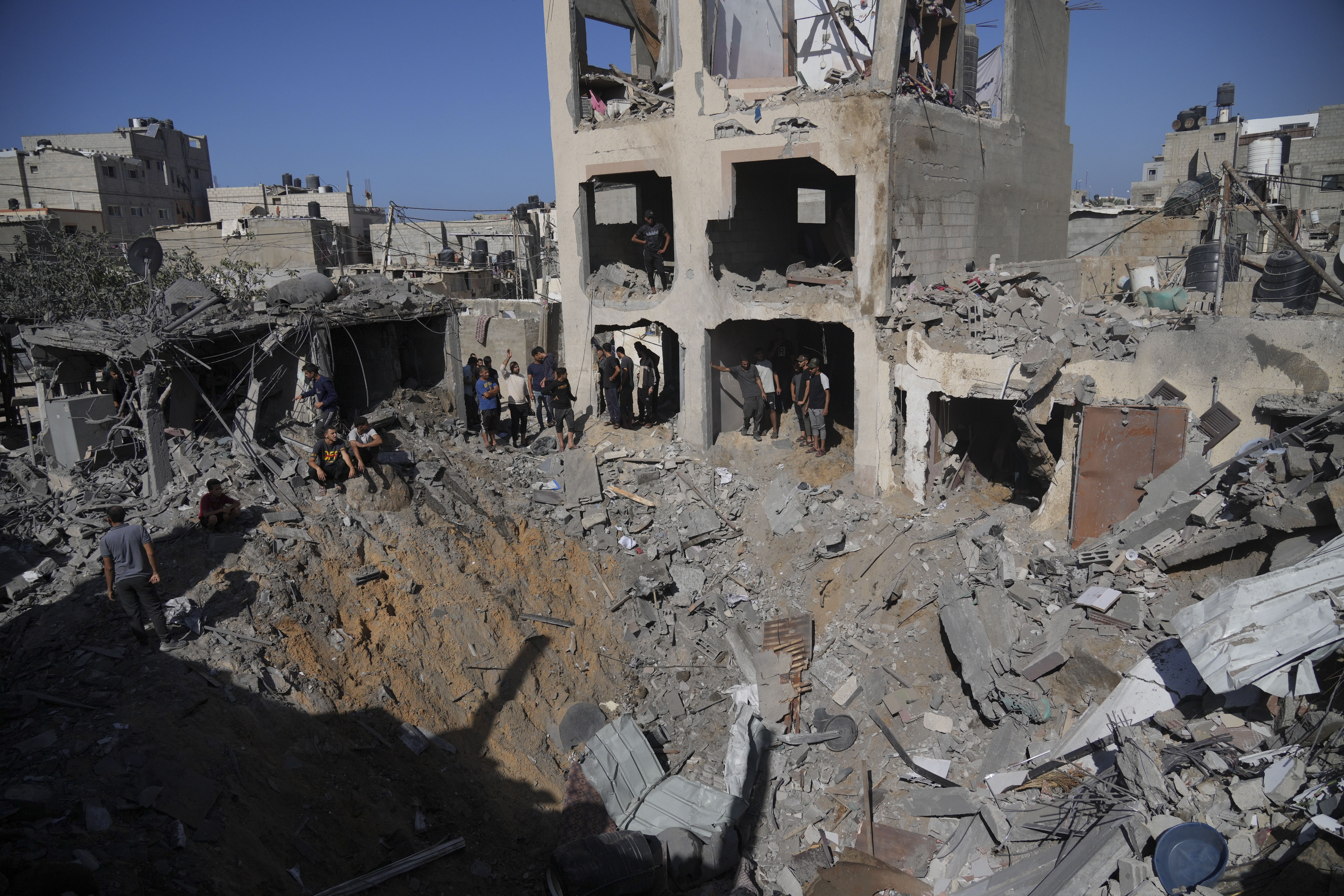 Palestinians look at buildings destroyed in the Israeli bombardment in the morgue in Deir al Balah, Gaza Strip.