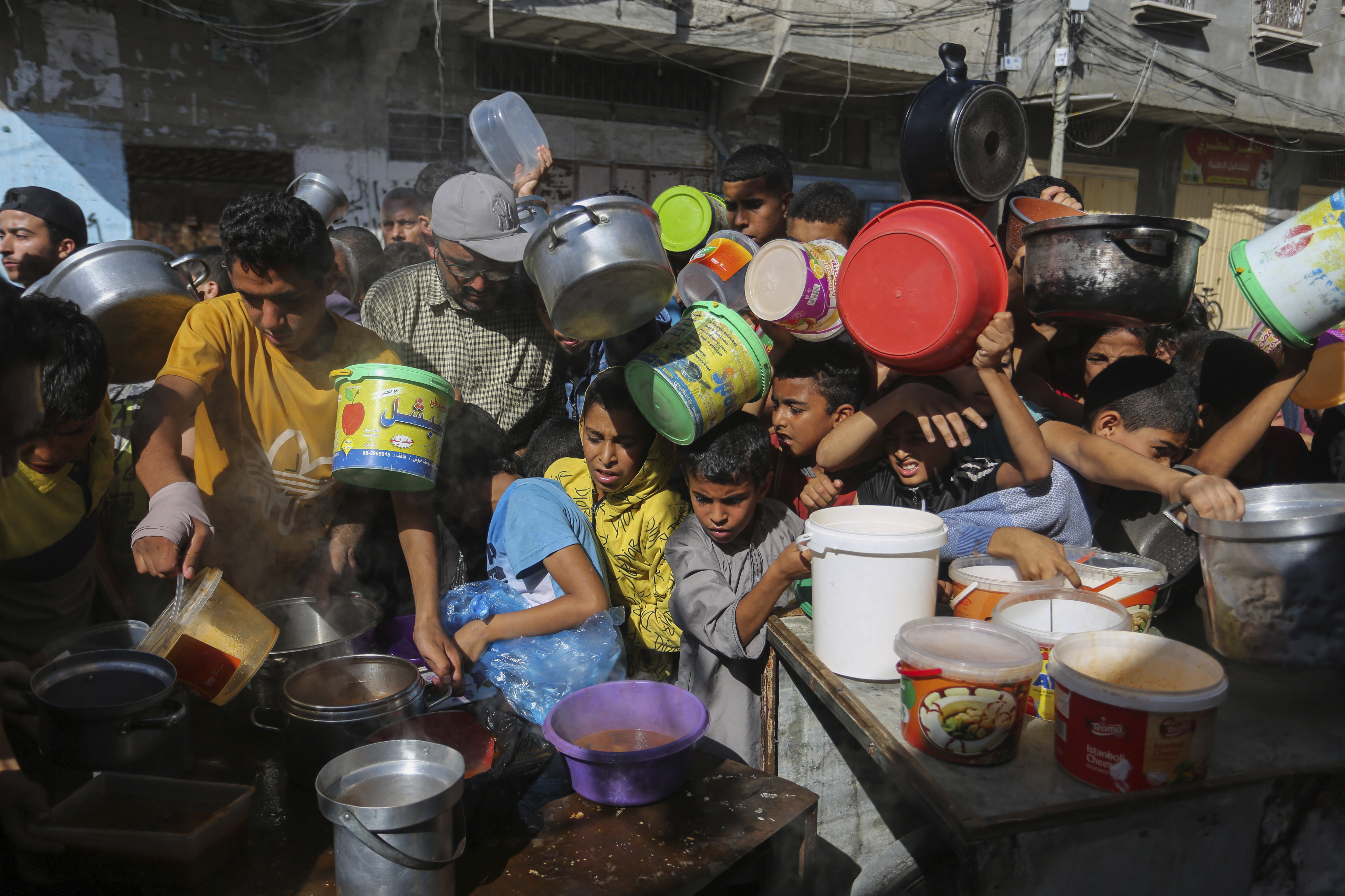 Palestinians crowded together as they wait for food distribution in Rafah, southern Gaza Strip.