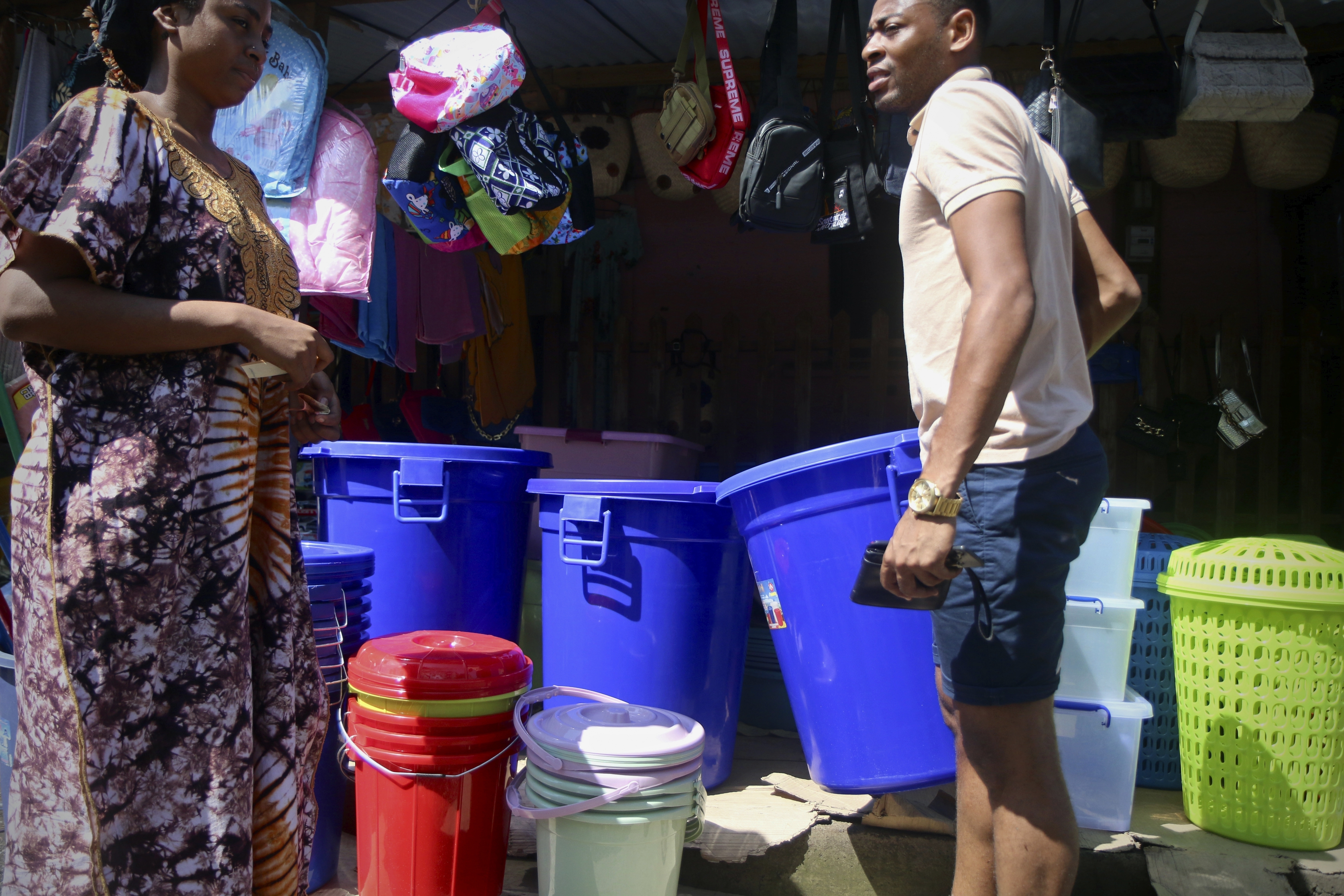 A woman sells water containers along the road in Chirongui, south of the French Indian Ocean territory of Mayotte.