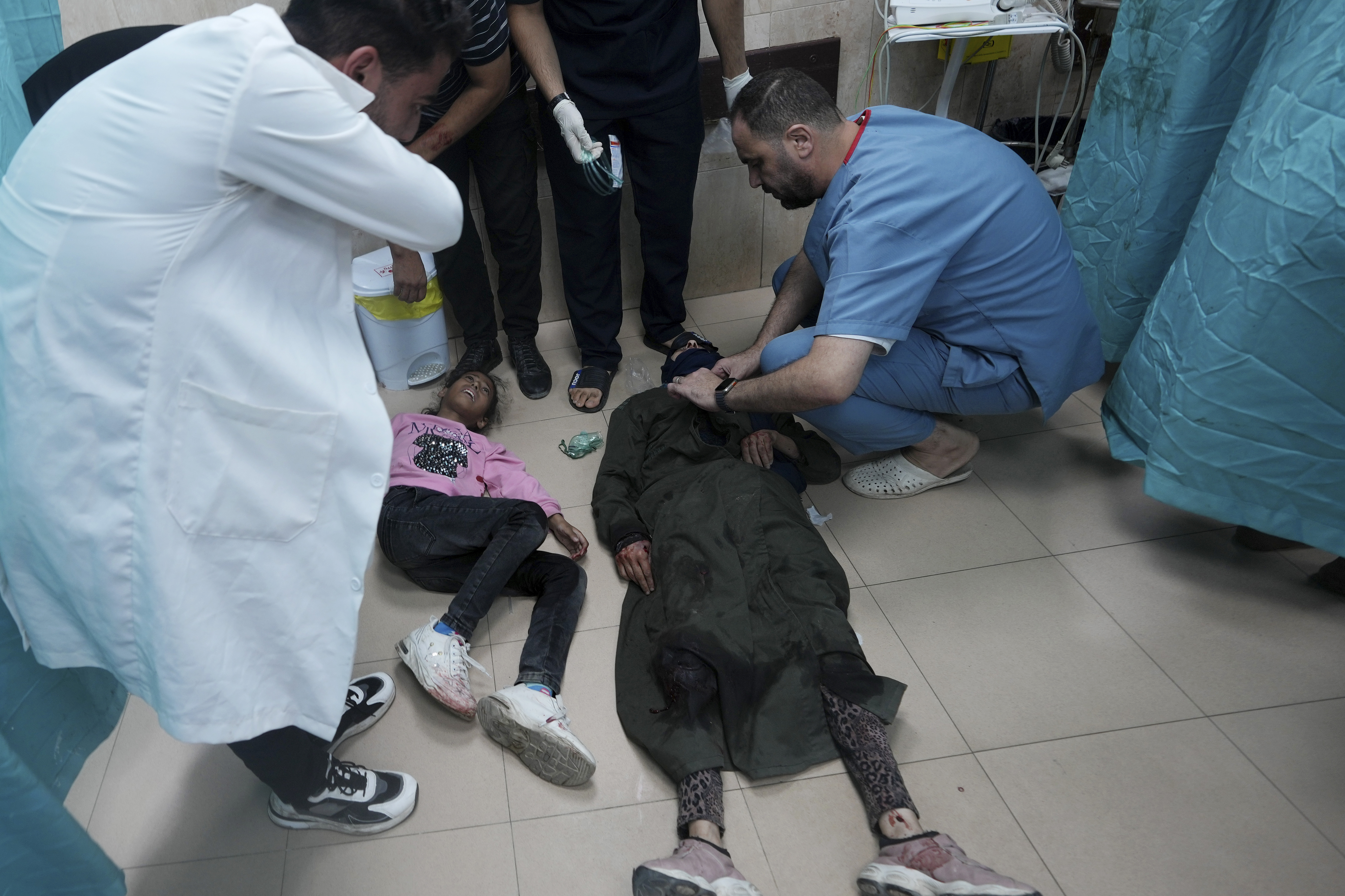 Palestinians wounded in the Israeli bombardment of the Gaza Strip are brought to a treatment room of al Aqsa Hospital on Deir al Balah