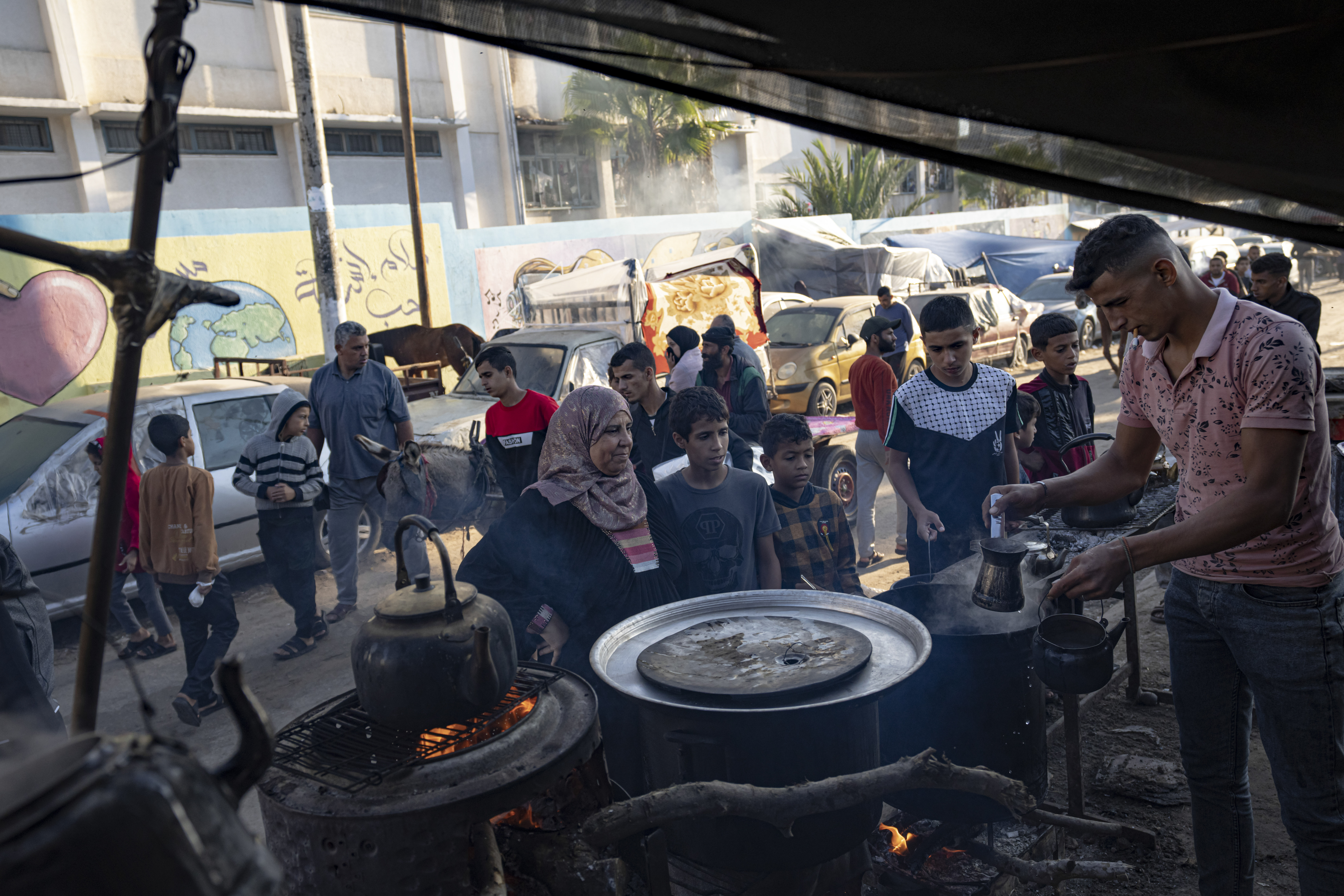 A Palestinian sells tea during the ongoing Israeli bombardment of the Gaza Strip in Khan Younis