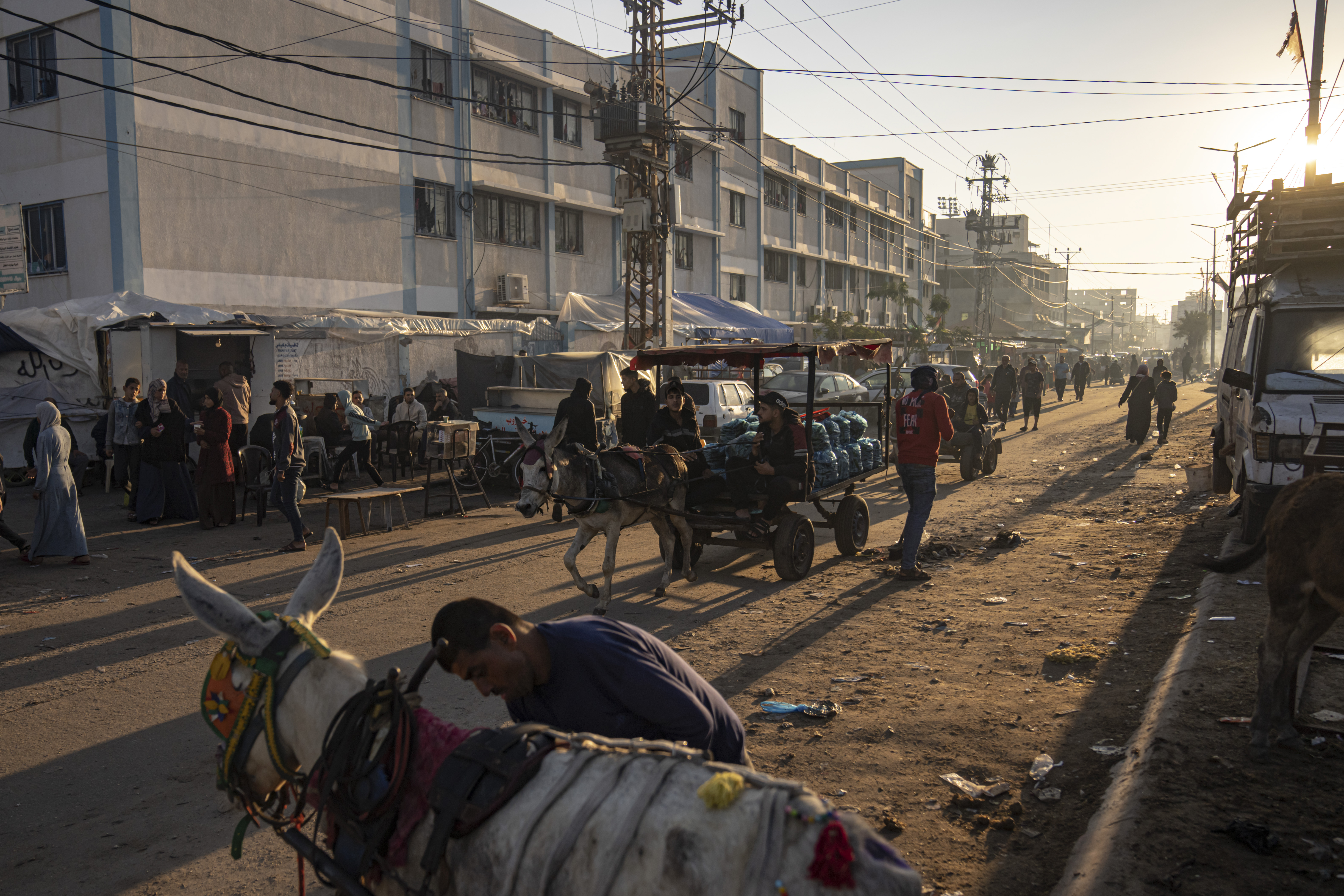 Palestinians ride donkey carts during the ongoing Israeli bombardment of the Gaza Strip in Khan Younis