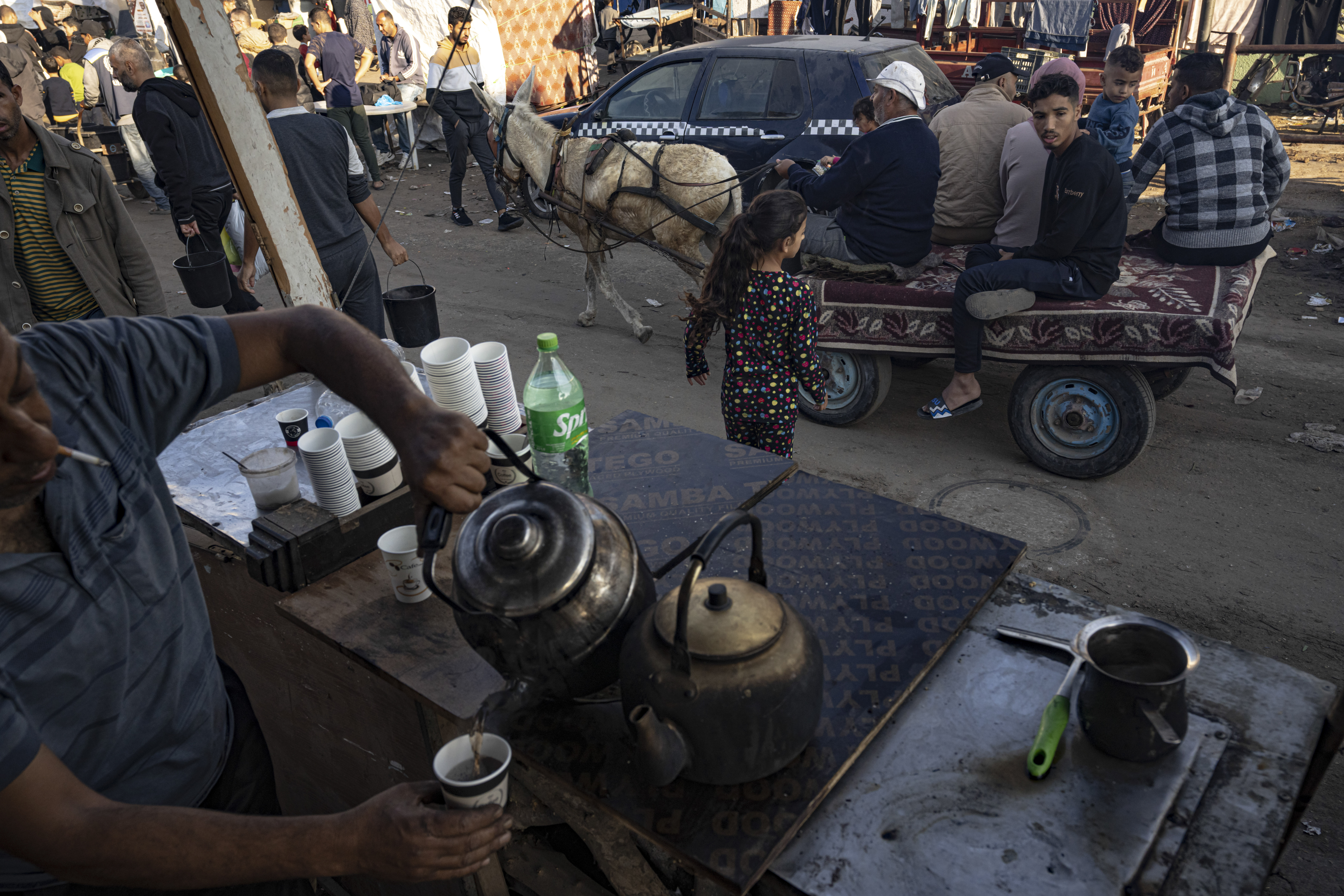 A Palestinian sells tea during the ongoing Israeli bombardment of the Gaza Strip in Khan Younis on Friday