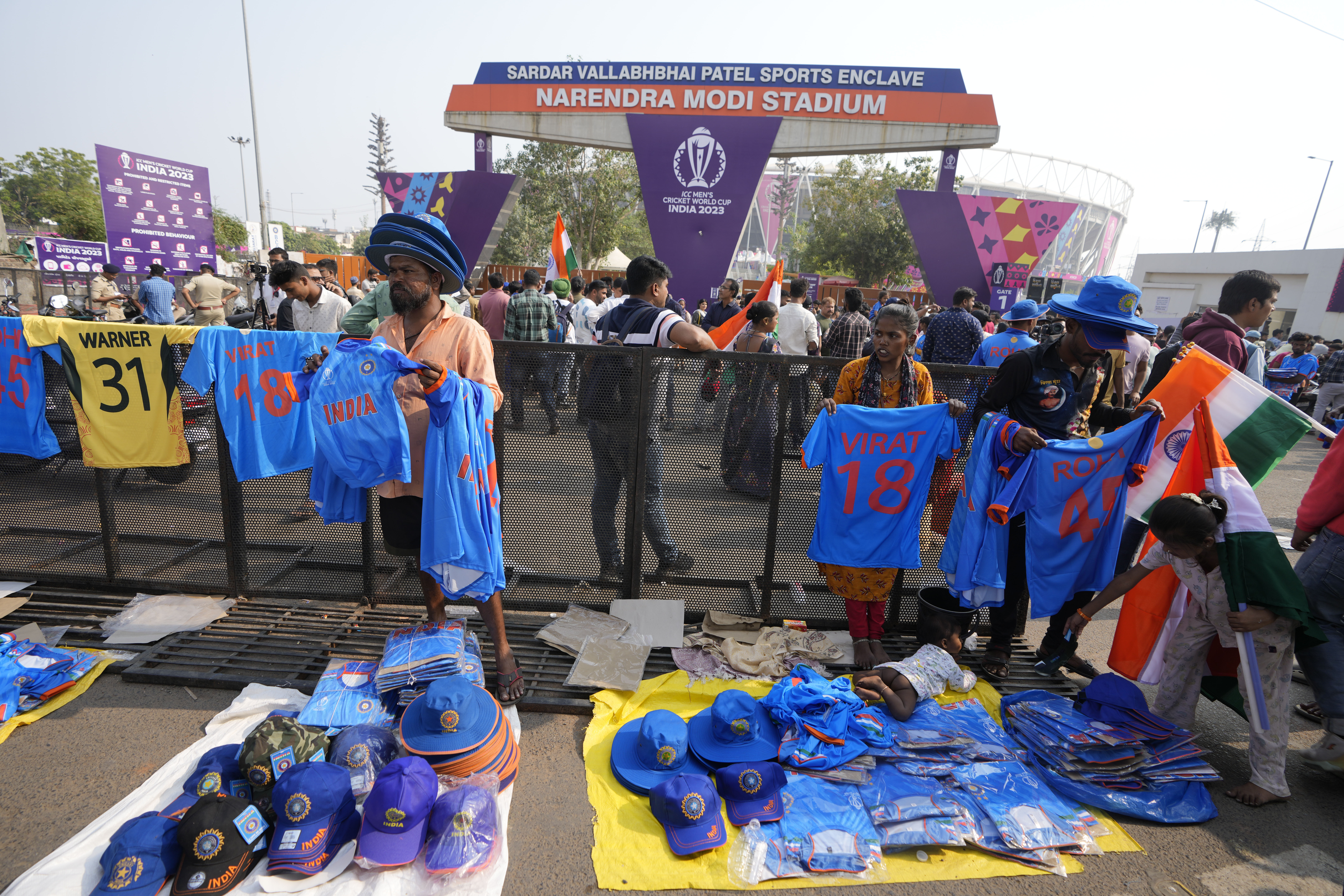 People sell cricket merchandise at Narendra Modi stadium