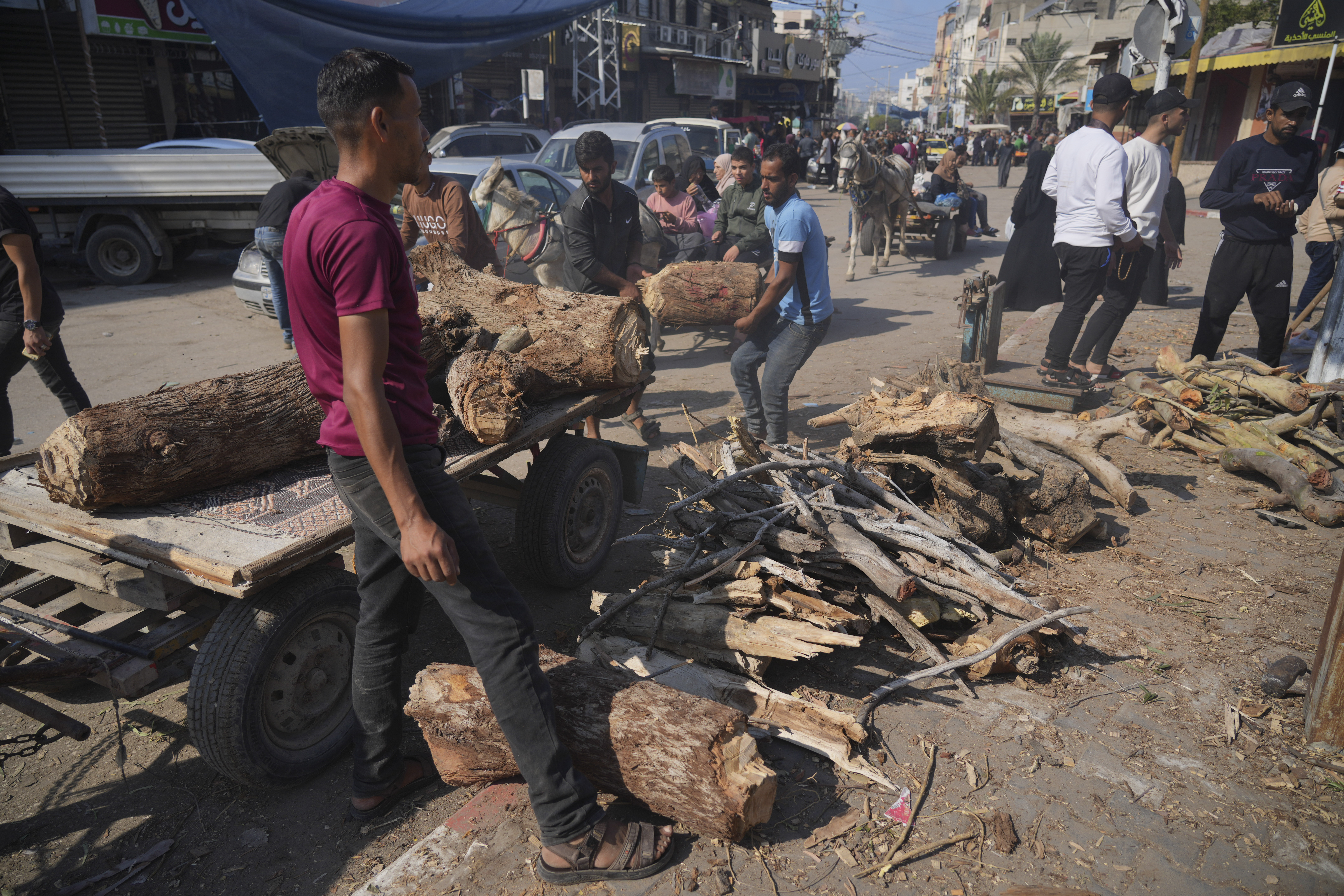 Palestinians sell firewood during the ongoing bombardment of the Gaza Strip in Deir al Ballah.