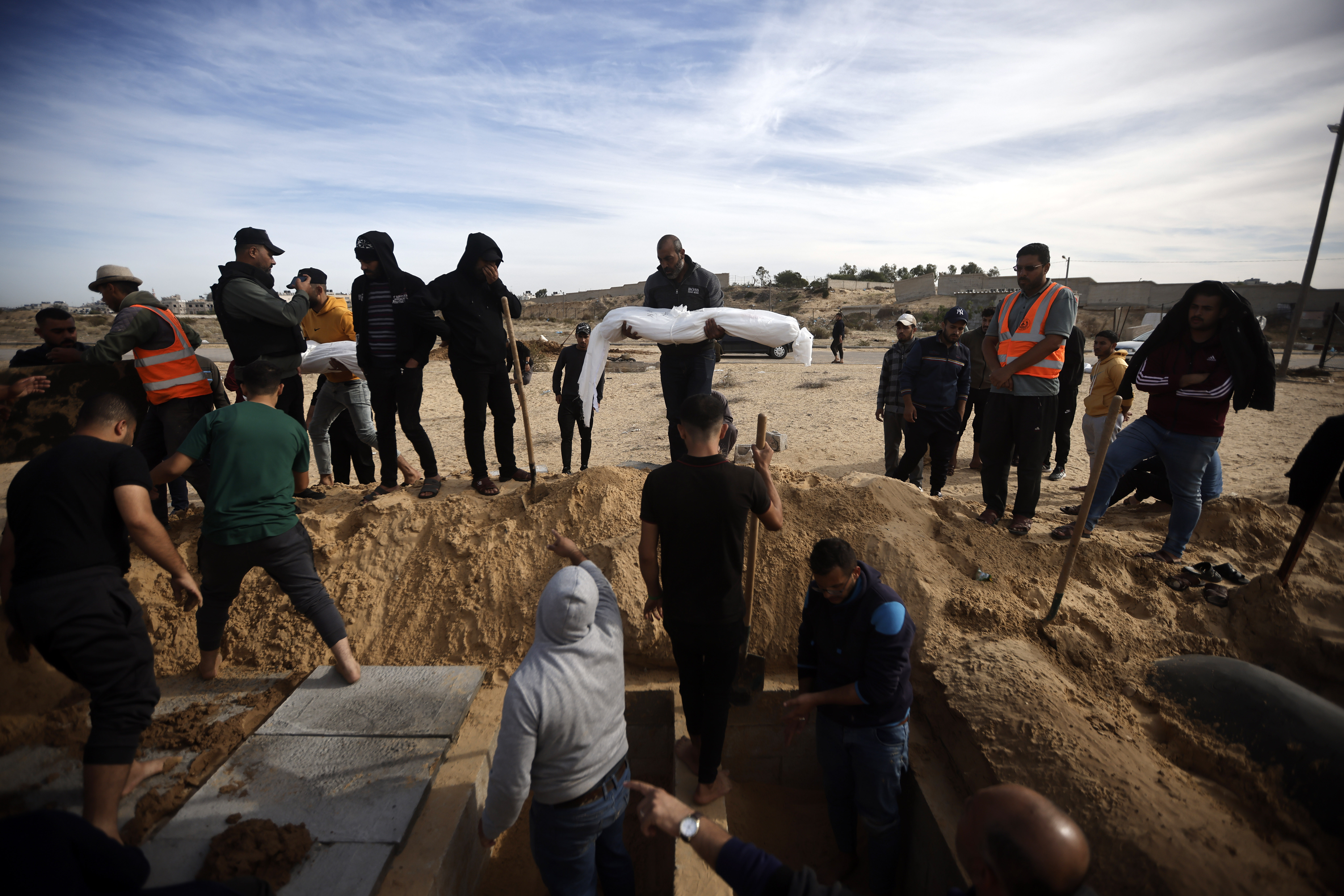 Palestinians burry their relatives, killed in the Israeli bombardment, in town of Khan Younis, southern Gaza Strip.