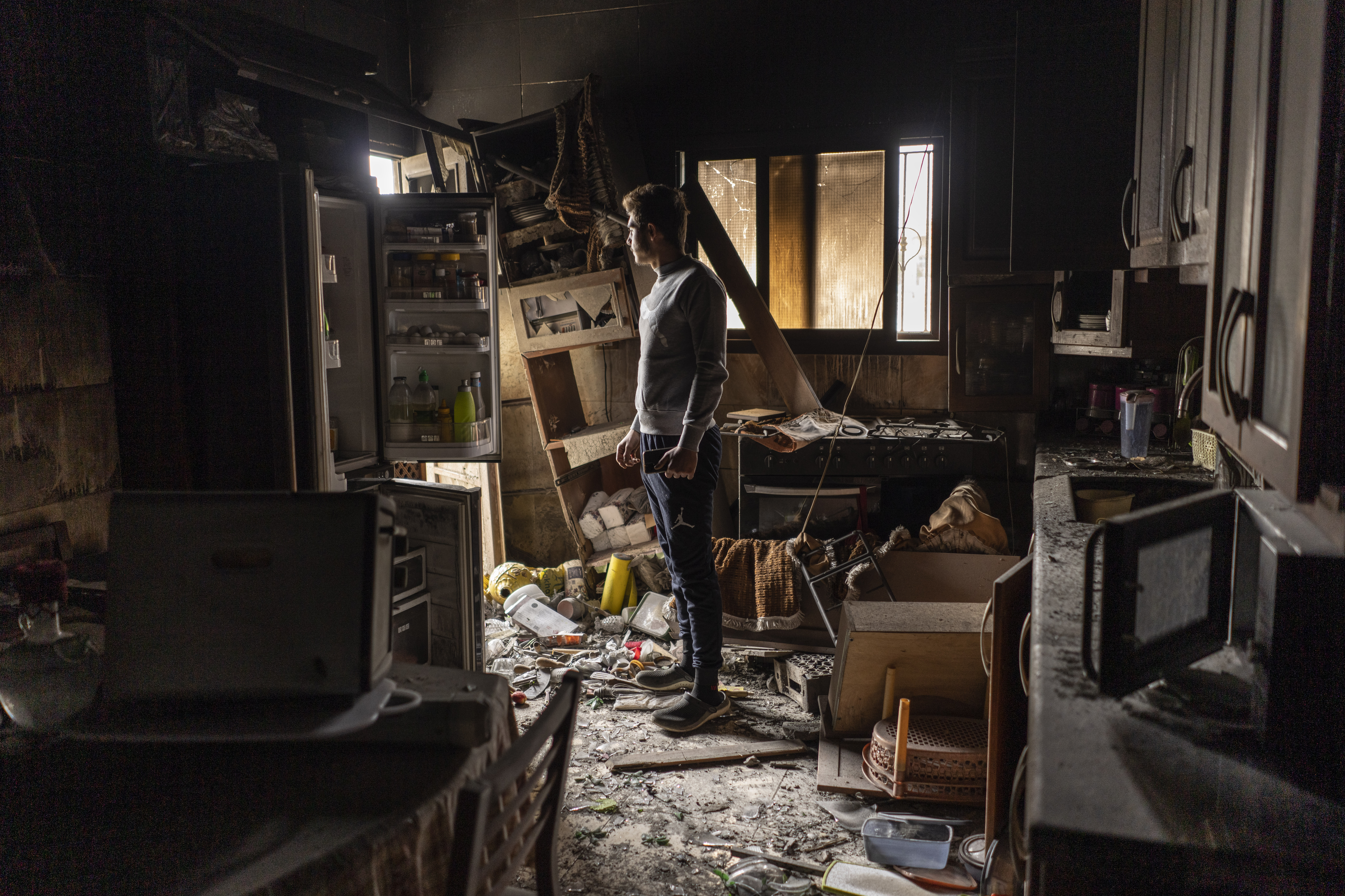 Ali Salman inspects damages to his family house that was hit by Israeli shelling in the Kfar Kila border village with Israel in south Lebanon.