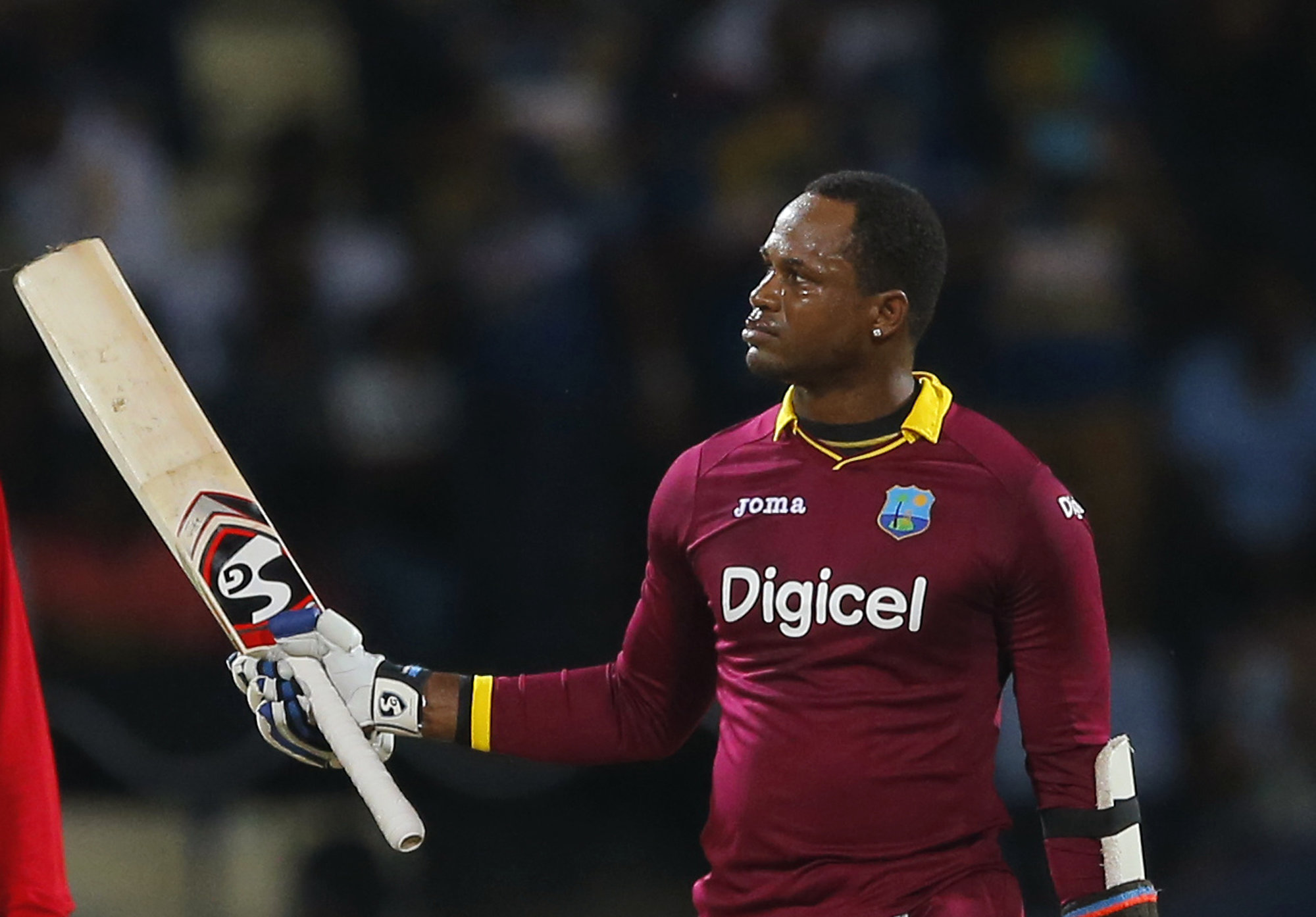 West Indies' Marlon Samuels acknowledges the crowd after scoring a century during their third one day international cricket match against Sri Lanka, in Pallekele, Sri Lanka, Saturday, Nov. 7, 2015. (AP Photo/Eranga Jayawardena)