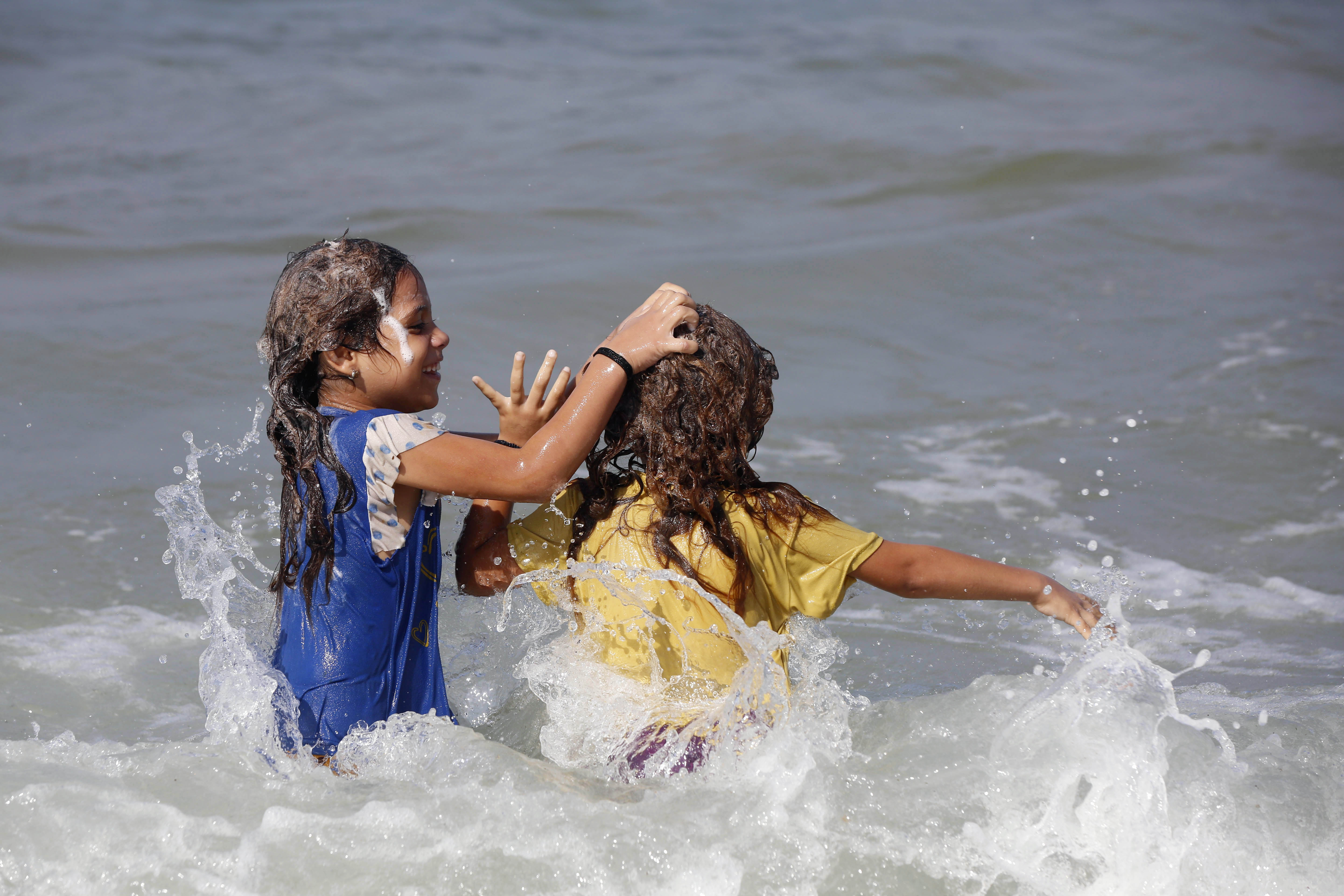 Palestinians using the sea to wash their clothes and bathe