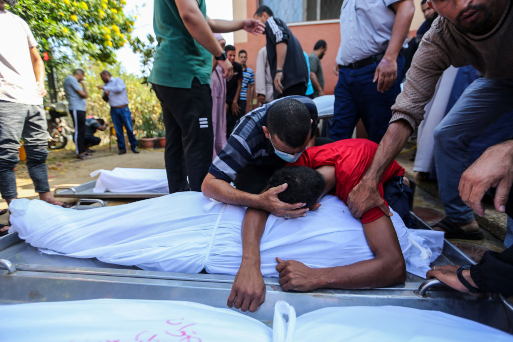People mourn as they collect the bodies of Palestinians killed in Israeli air raids in Khan Yunis, Gaza.