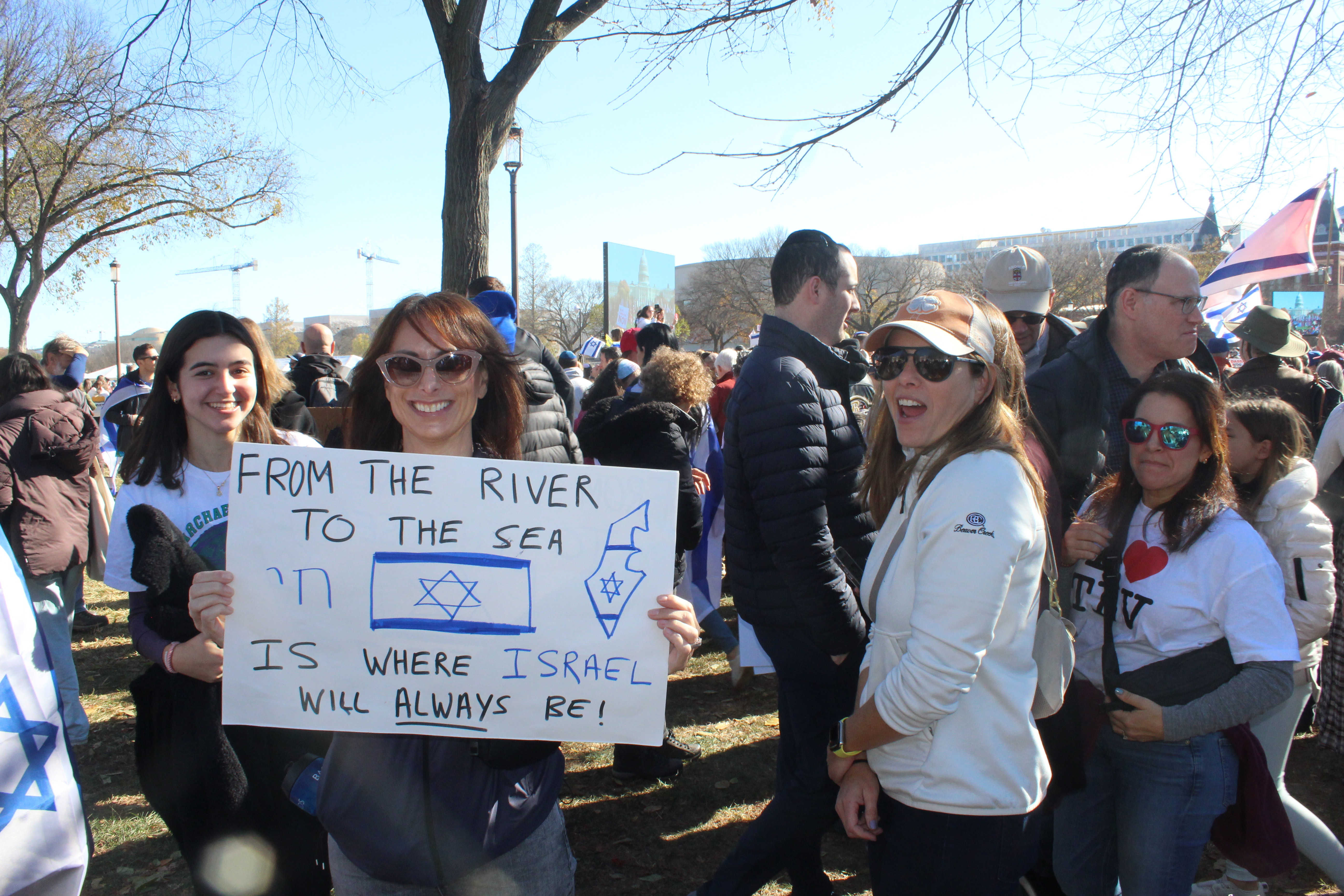 Woman holds a sign that says, "From the River to the Sea, is where Israel will always be"