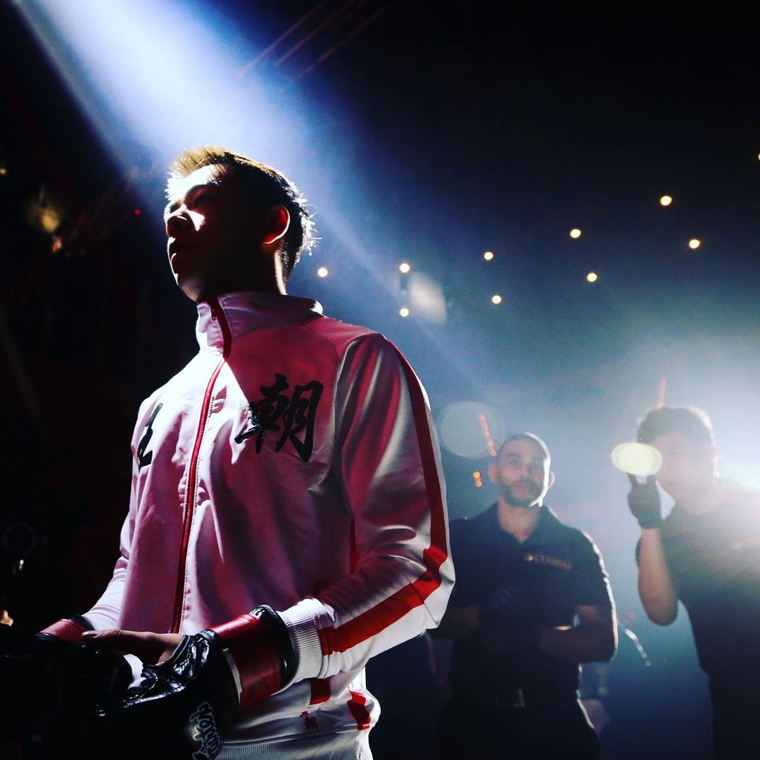 Khai Wu under a spotlight as he makes he way to the ring