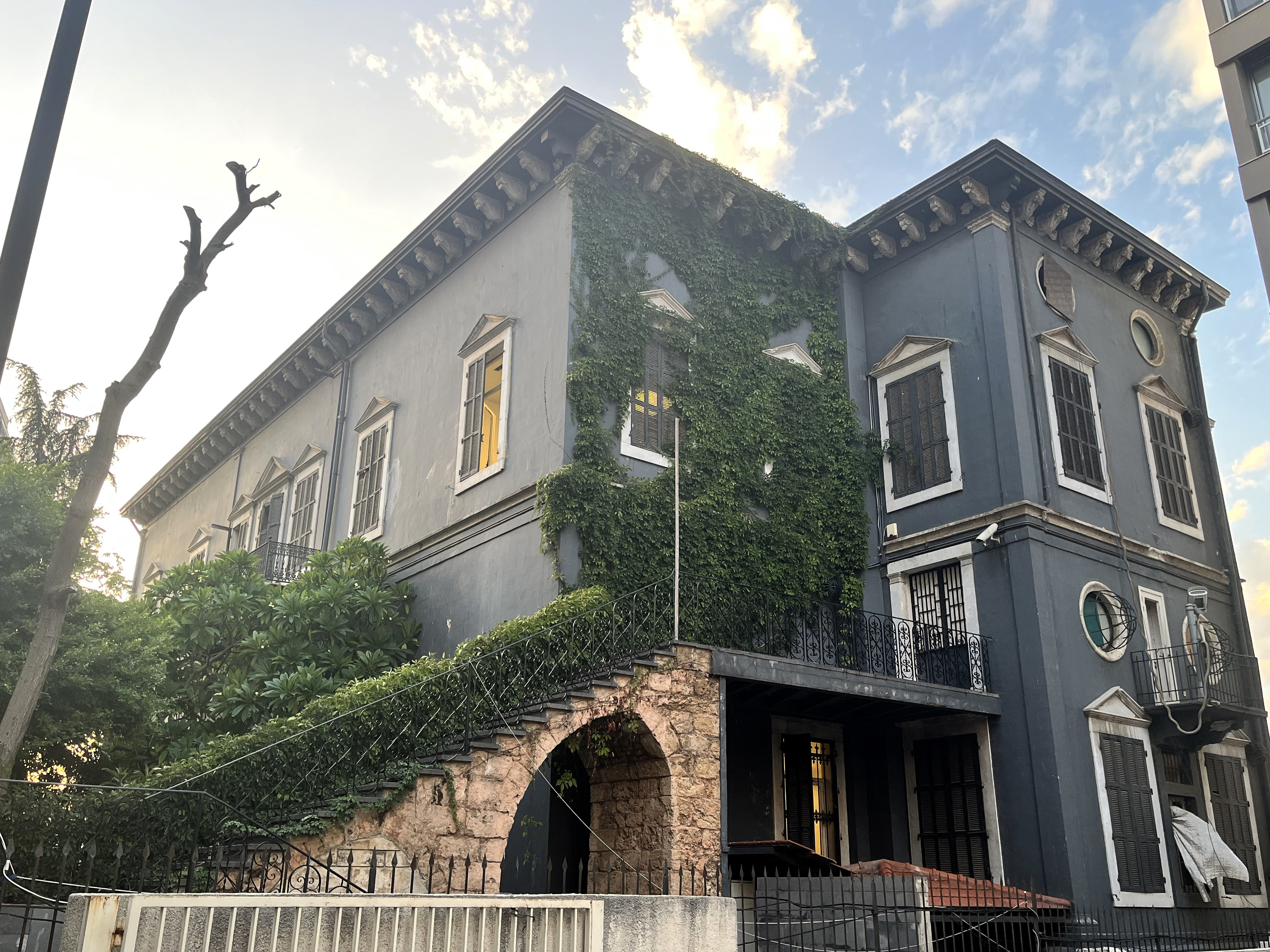 Dark grey villa with white trim