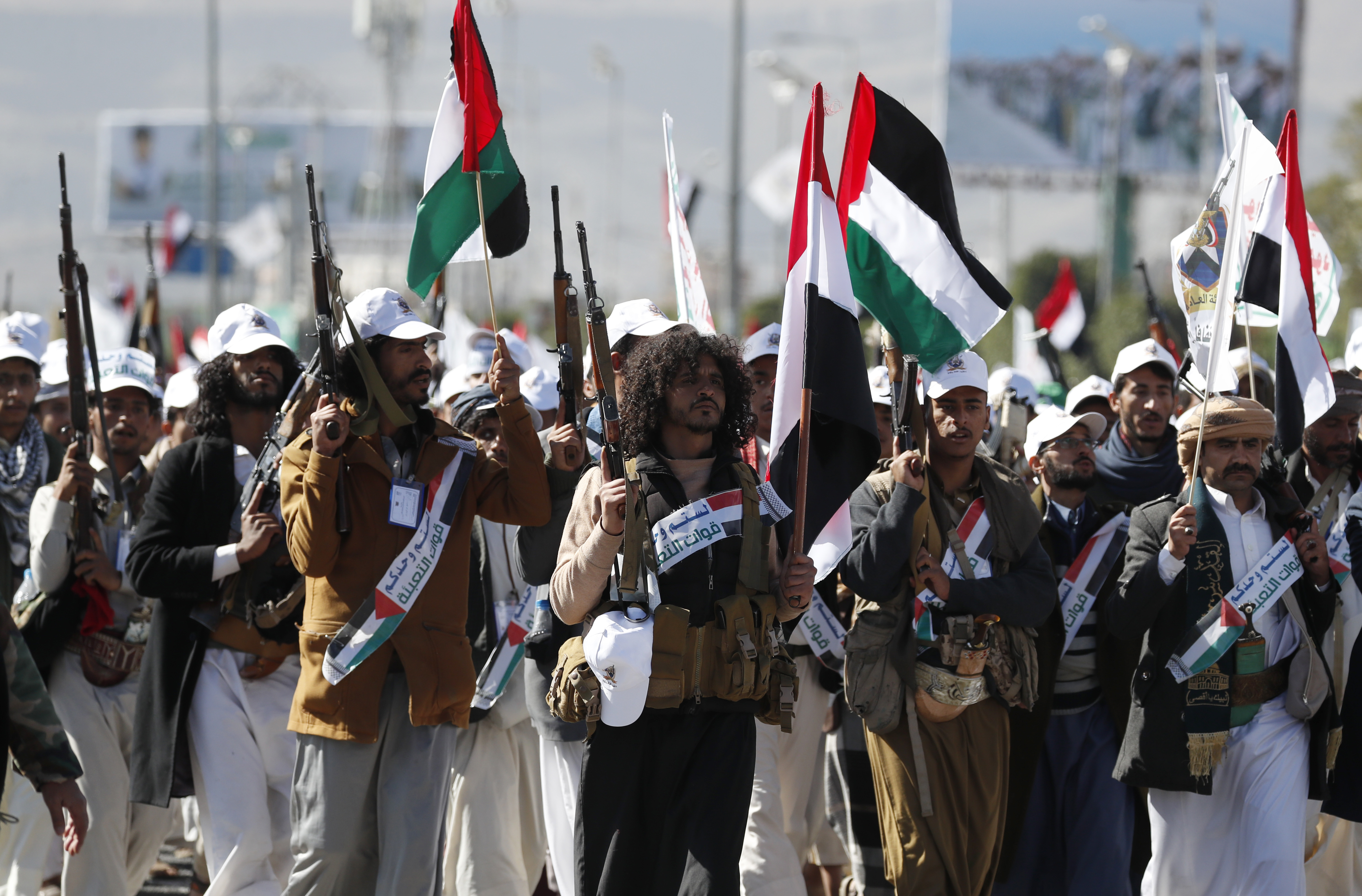 Newly-recruited members of the Houthis' popular army march during a parade in Sana'a, Yemen