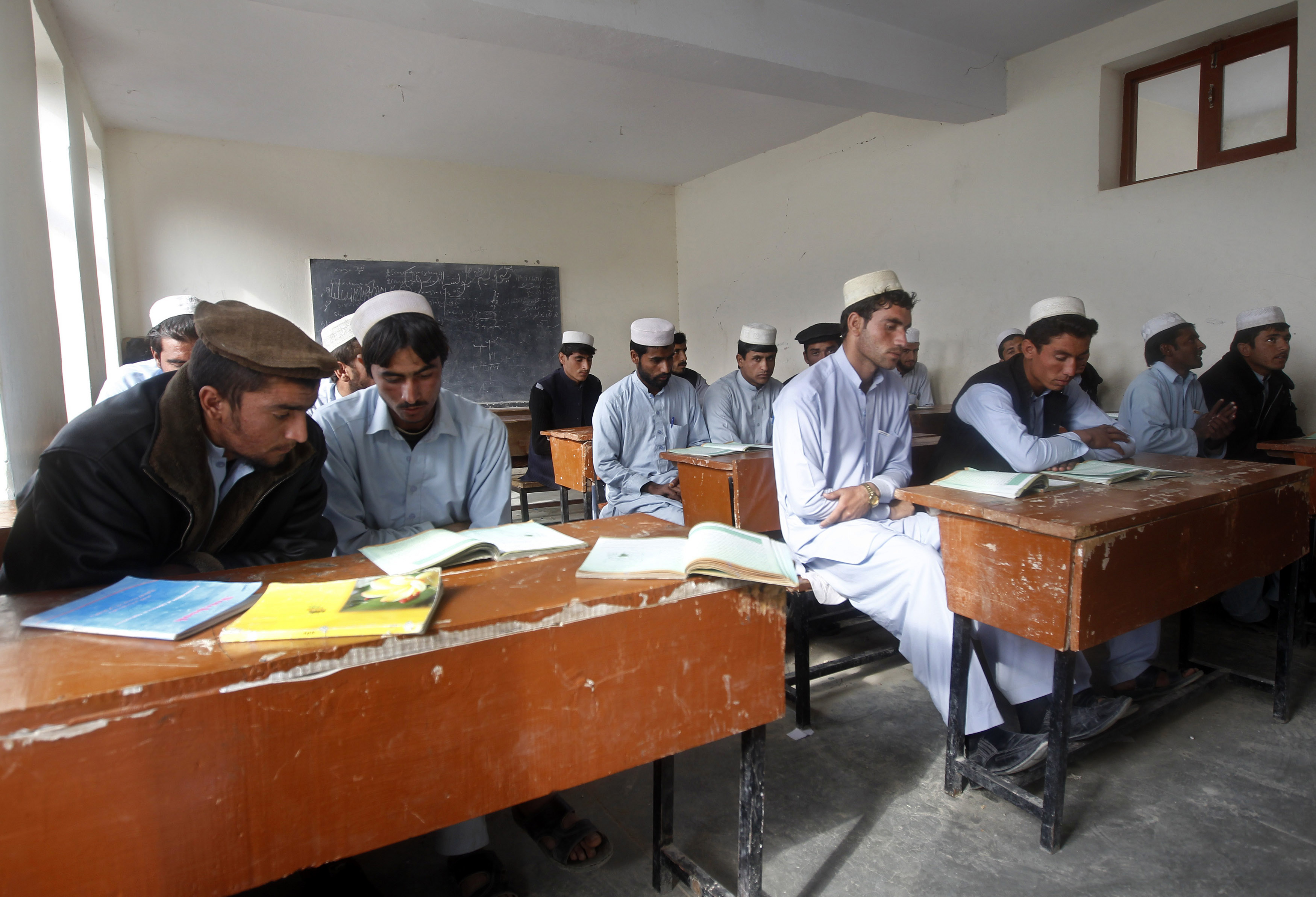Afghan students attend class in a school built by an Indian project in the Achin district of Jalalabad province December 2, 2013. India's most important message for Afghanistan is that it is not leaving, and it is backing that message with the biggest aid package it has ever given another country. Indian diplomats insist the message is meant as reassurance for allies in Afghanistan nervous about waning international support as NATO withdraws its troops. Yet it could equally have been chosen to send a warning to India's arch-rival, Pakistan. The nuclear-armed neighbours both want to secure influence in Kabul after foreign combat forces leave this year, and both are using aid as part of their strategy.