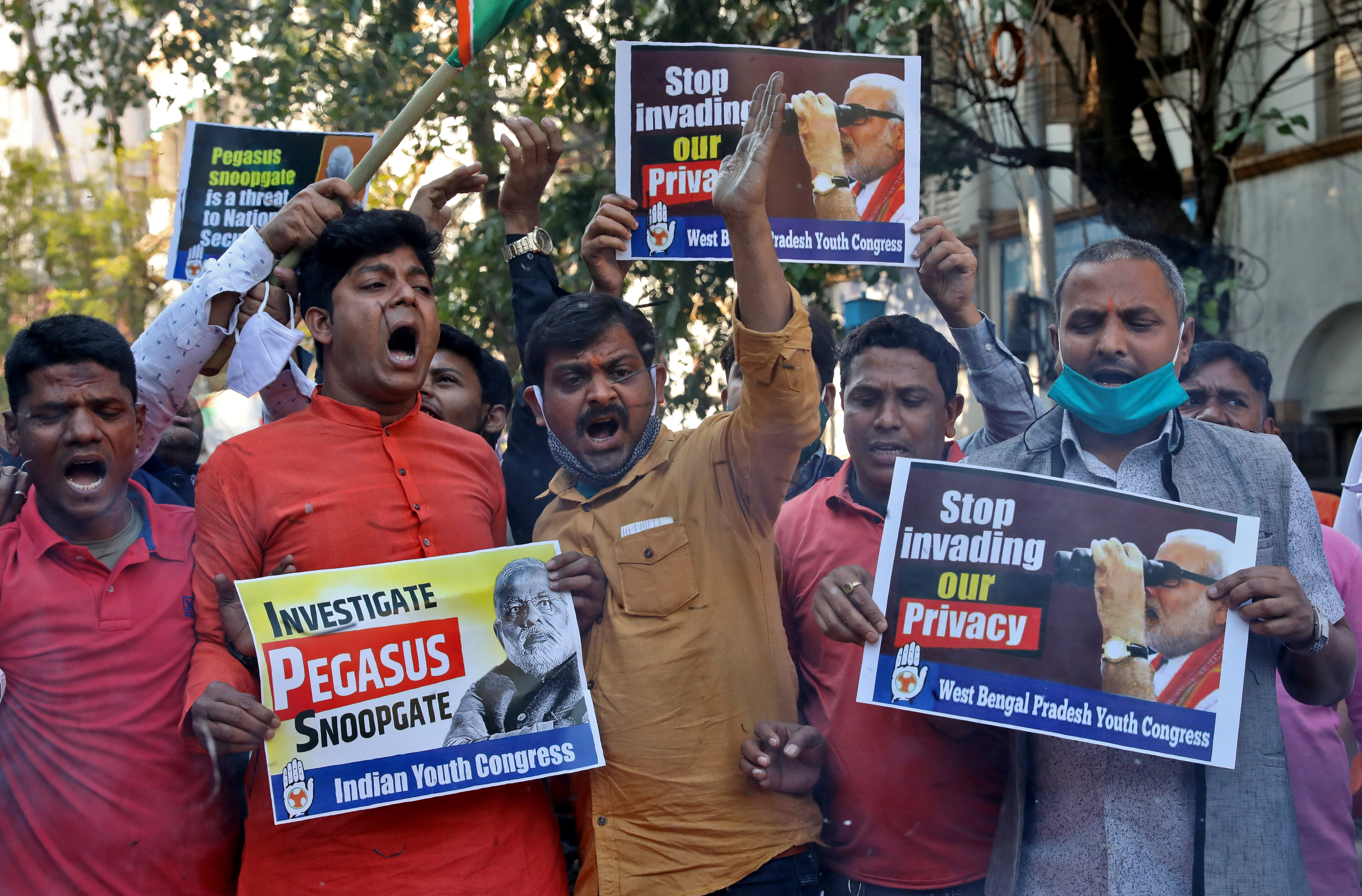 Supporters of India's main opposition Congress party hold placards as they shout slogans against India's Prime Minister Narendra Modi during a protest against what they say is use of Pegasus to spy on activists, journalists and politicians, in Kolkata, India,