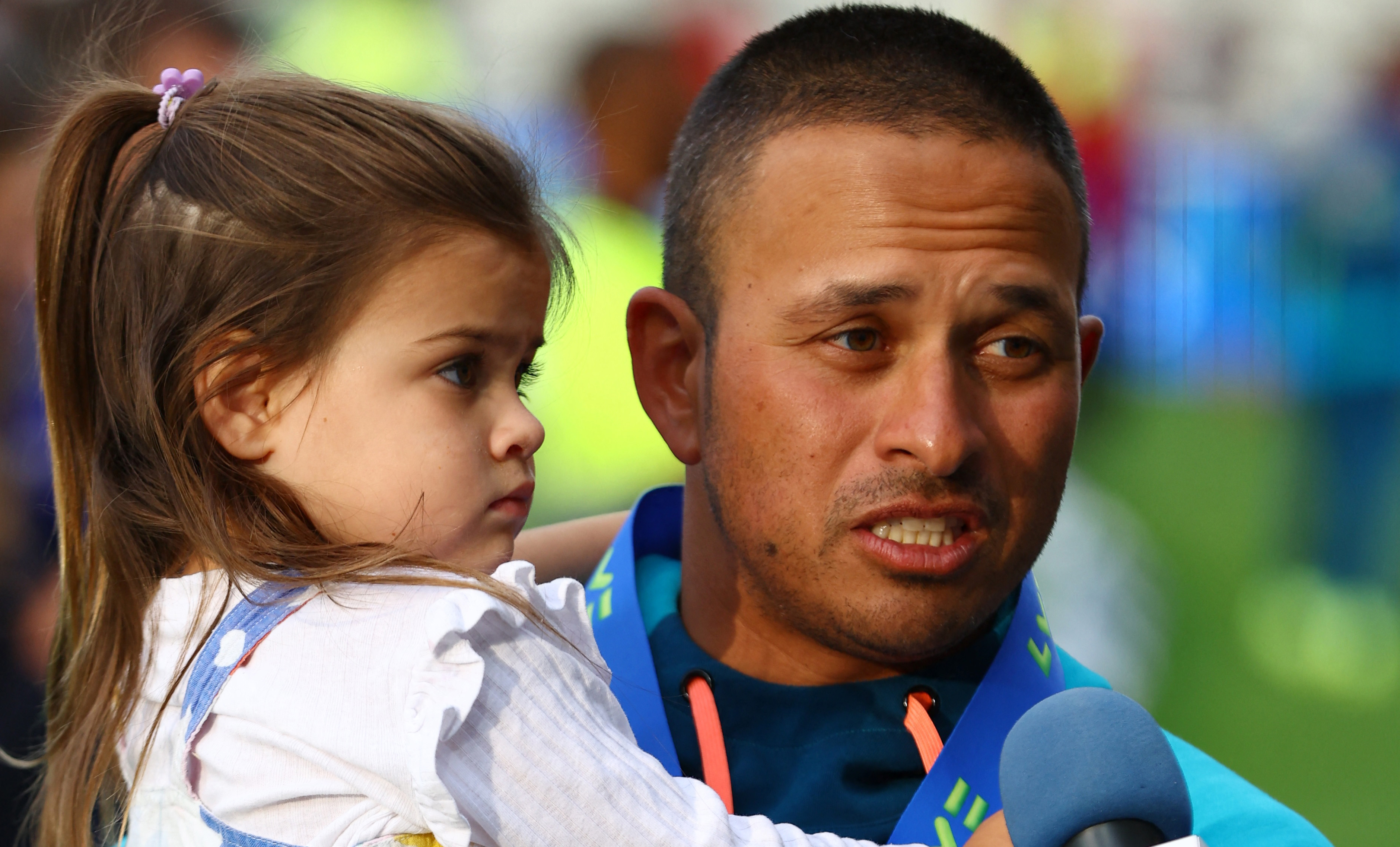 Usman Khawaja holds his daughter Aisha
