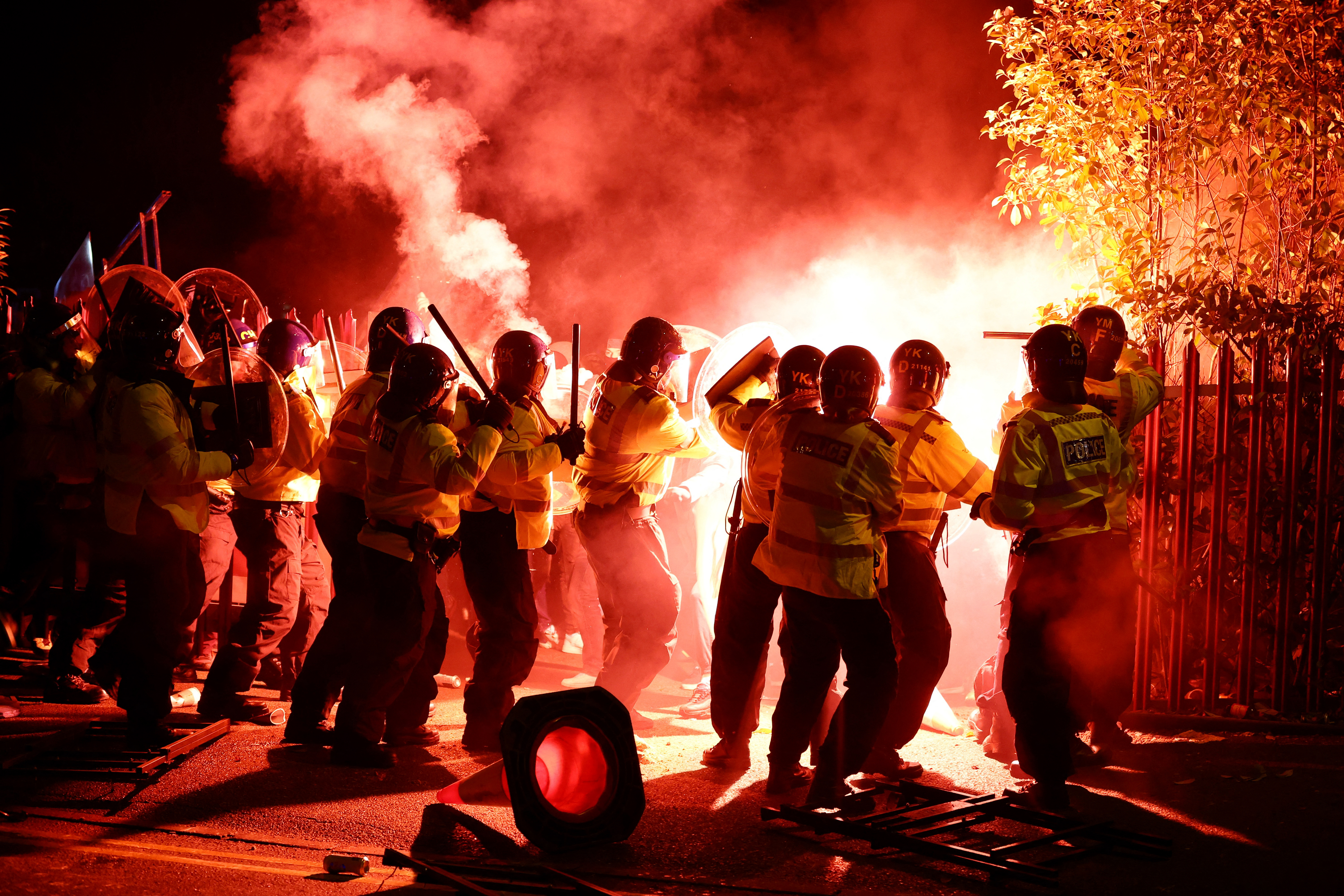 Legia Warsaw fans let off flares as they clash with police officers