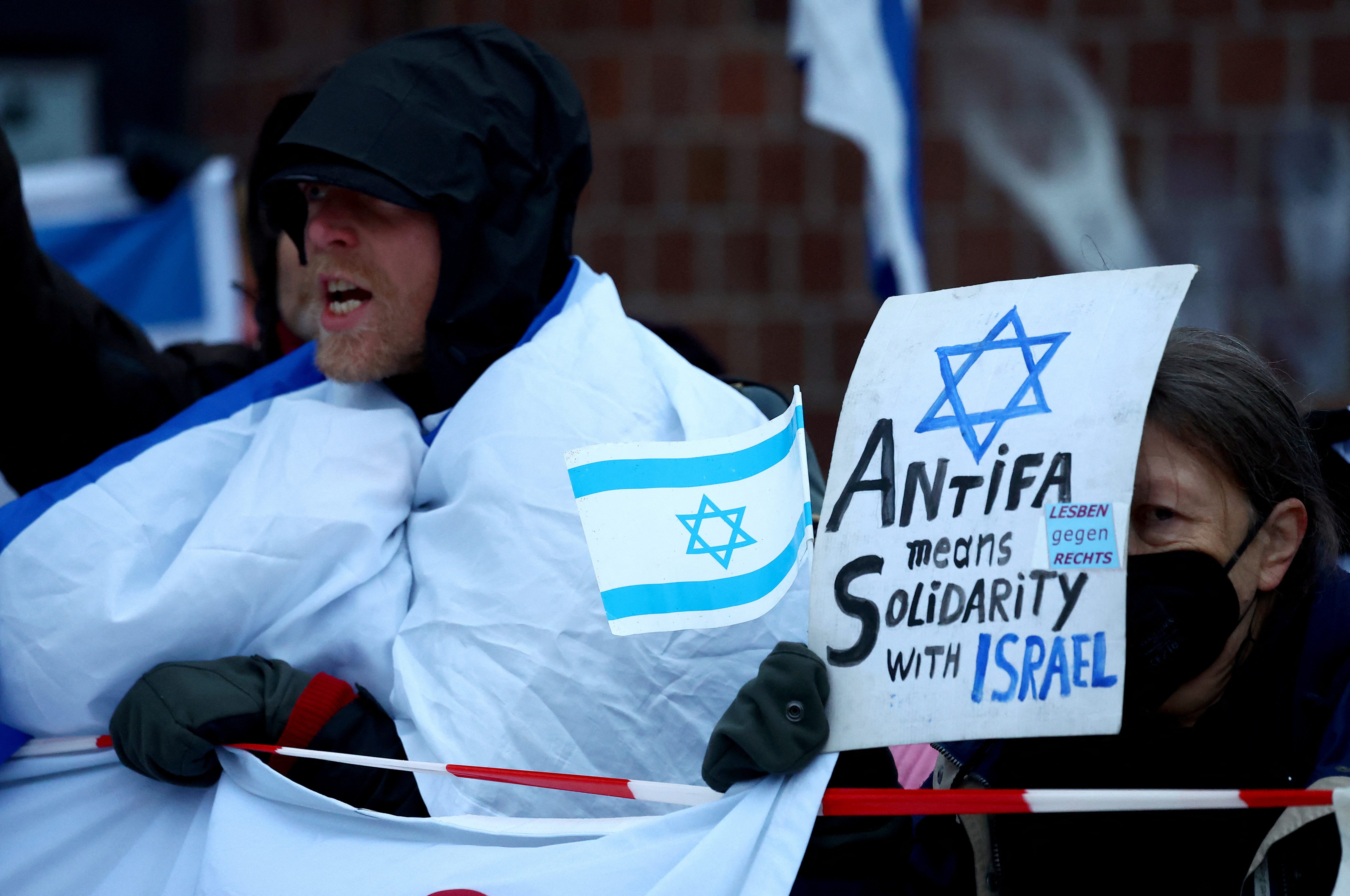 Counter protesters hold pro-Israel signs during a pro-Palestinian demonstration, in Berlin, Germany, December 2, 2023 [Lisi Niesner/Reuters]