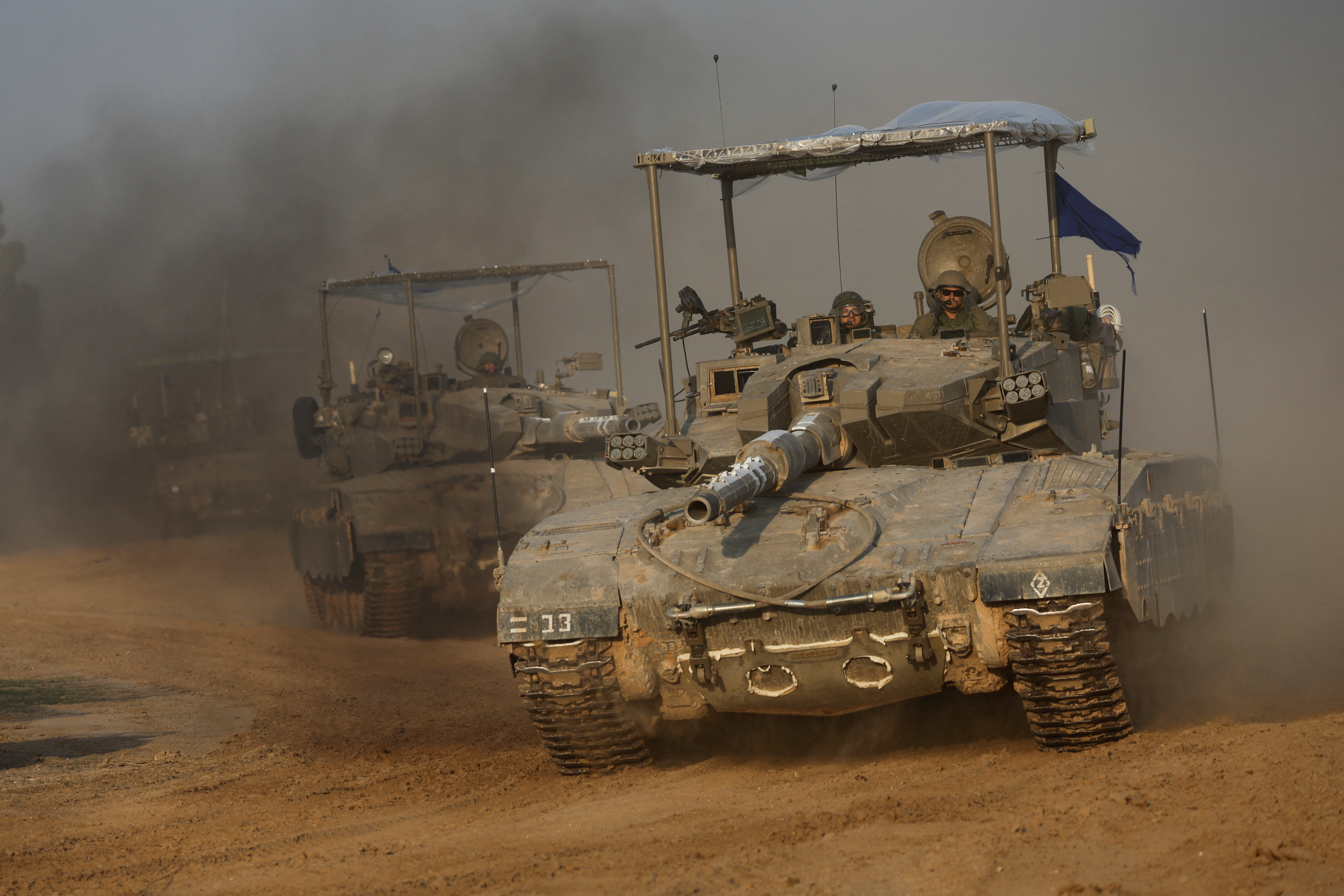 A convoy of Israeli tanks maneuvers near Israel's border with Gaza