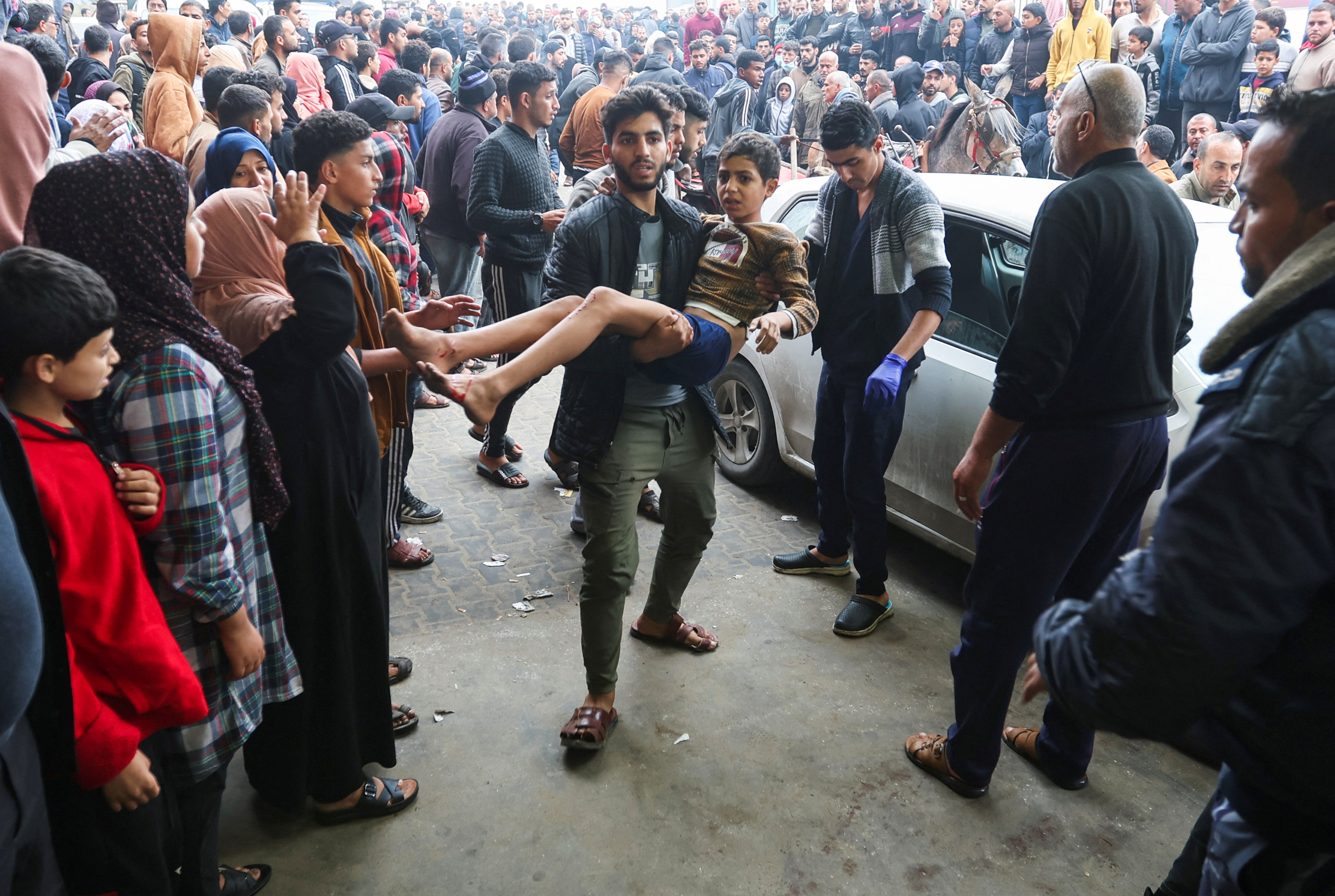 A wounded Palestinian child is brought into Nasser hospital