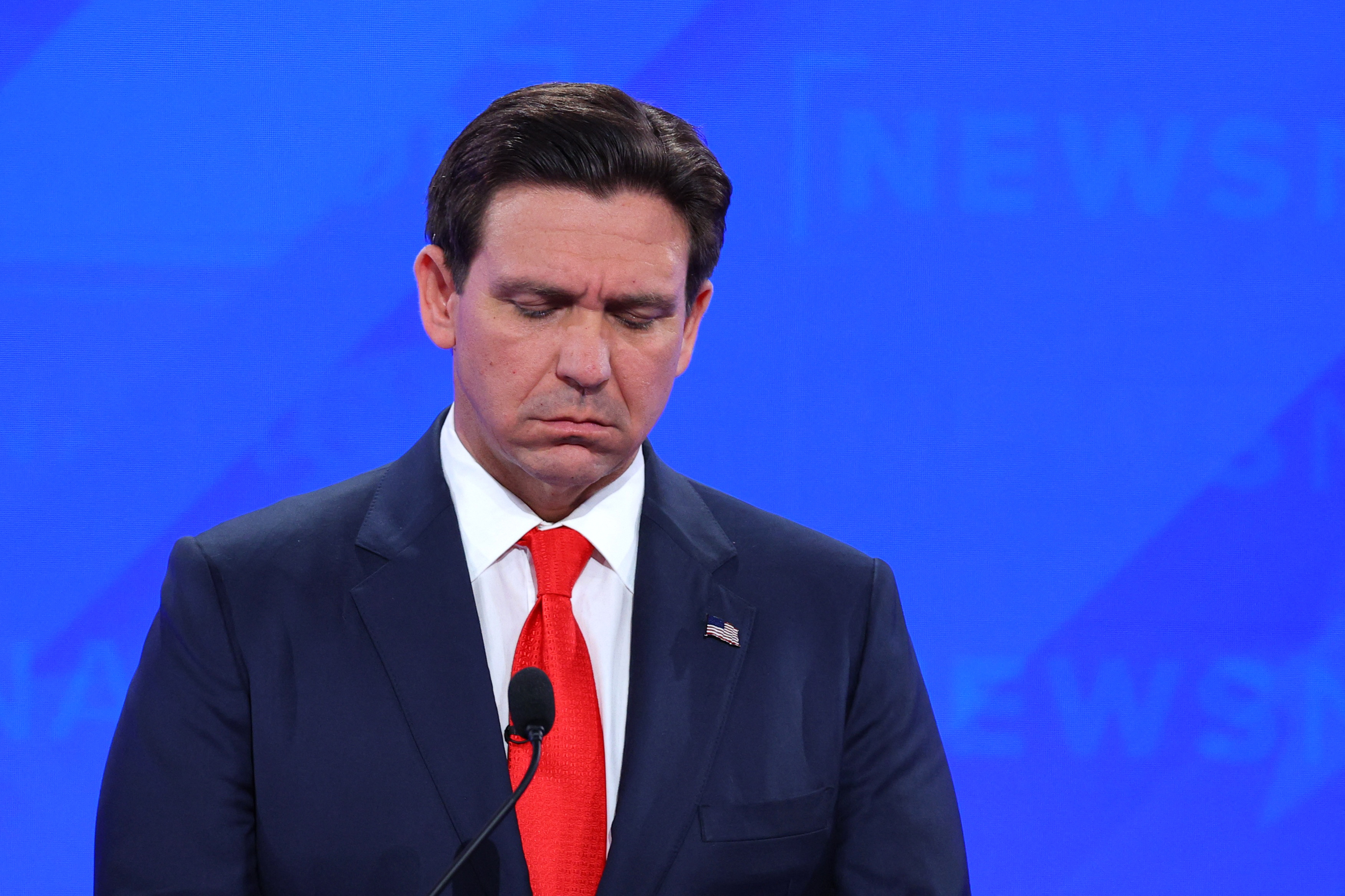 Ron DeSantis against a blue screen at the debate.