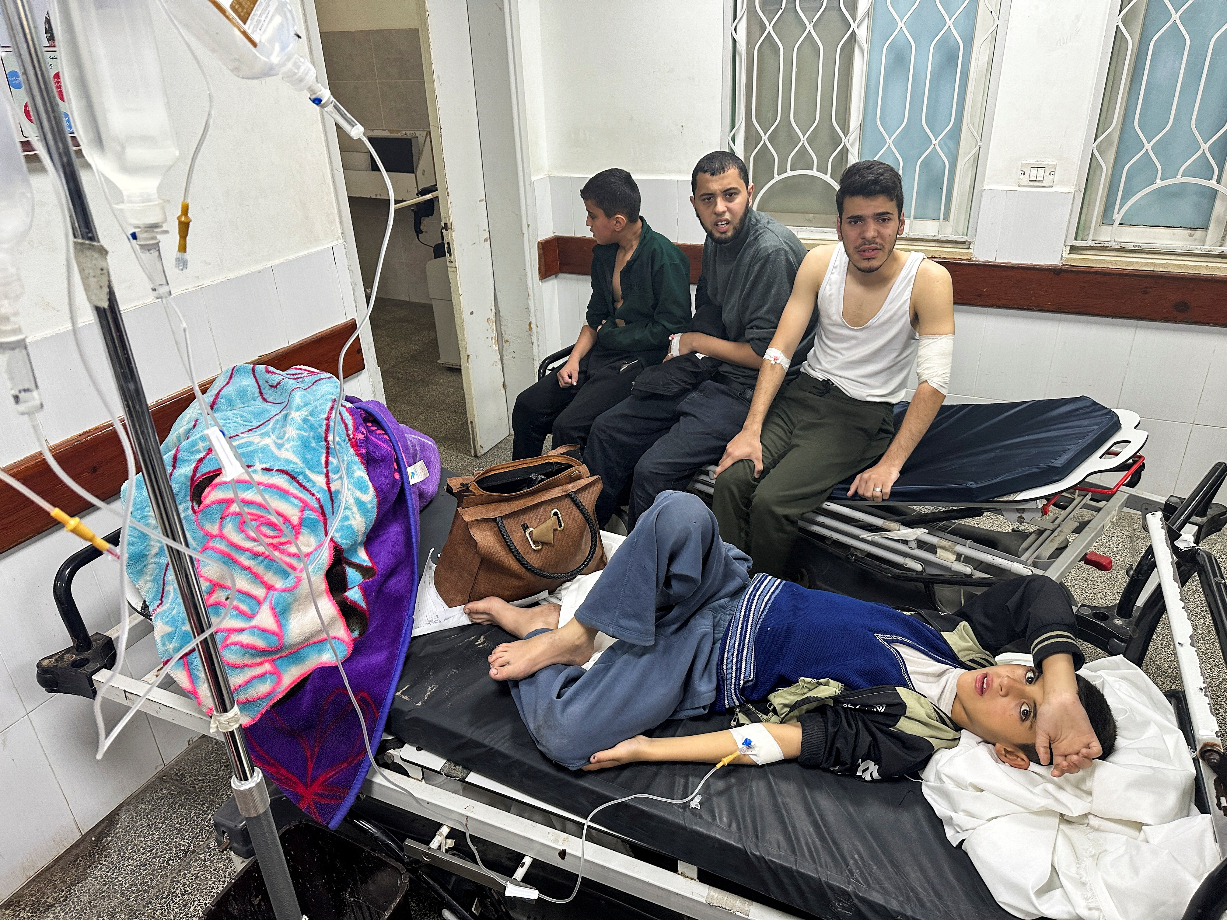 A Palestinian boy, who is diagnosed with gastroenteritis, lies on a bed as he receives treatment in a hospital, amid doctors warning of the spread of diseases and infections among Gazan children due to the ongoing conflict between Israel and Hamas, in Rafah, in the southern Gaza Strip.